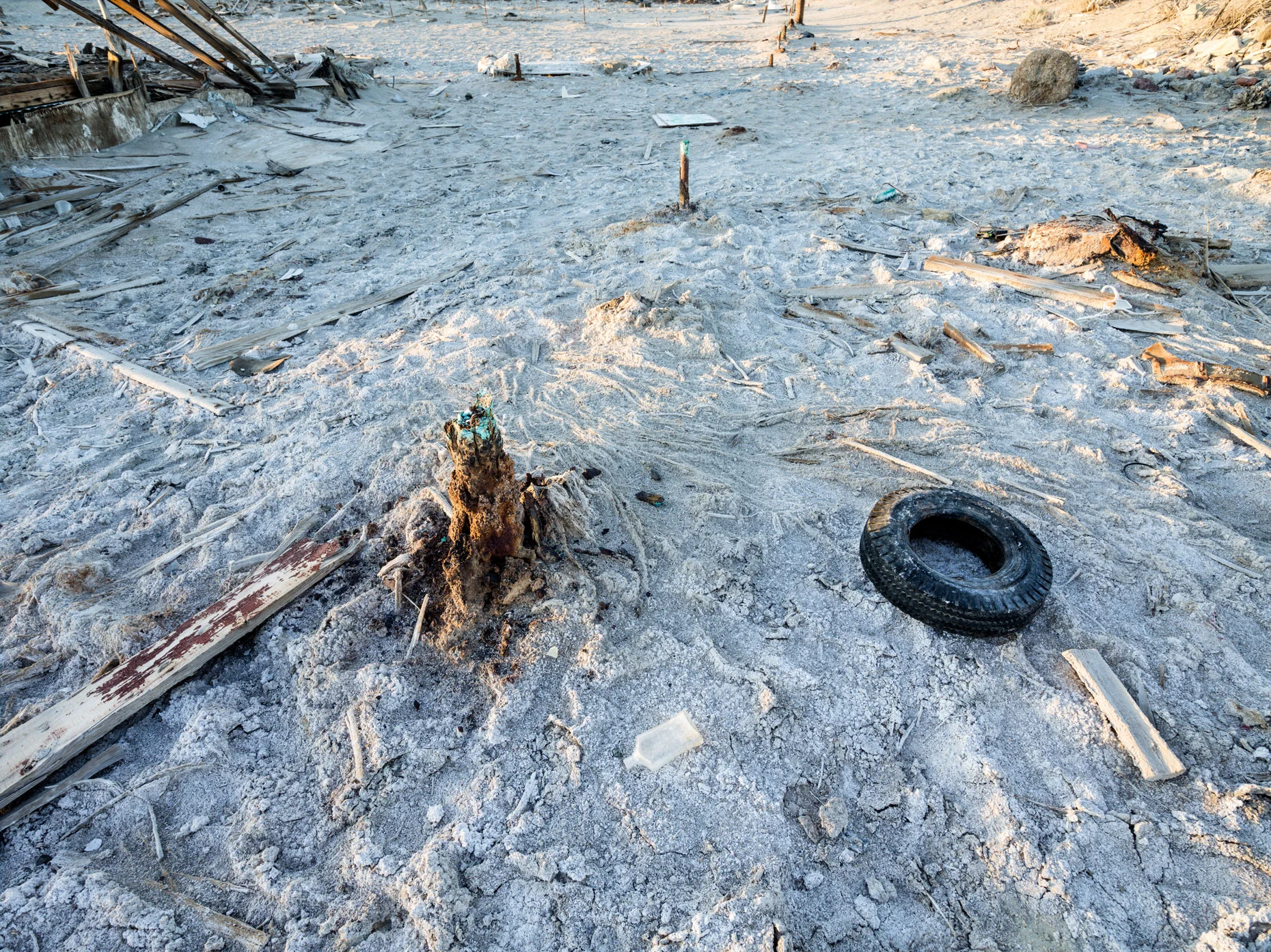 Salton Sea sand castle with tires and other garbage on the Bombay Beach shoreline