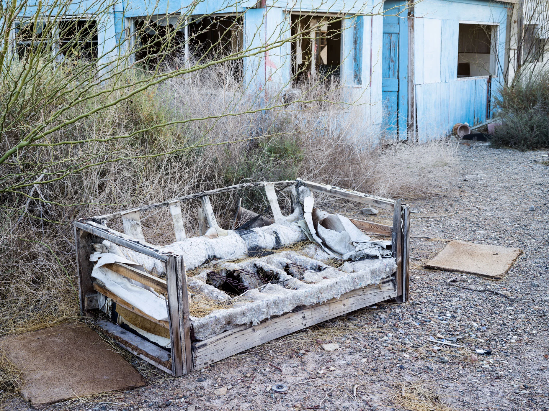 Bombay Beach weathered couch outside of an abandoned building
