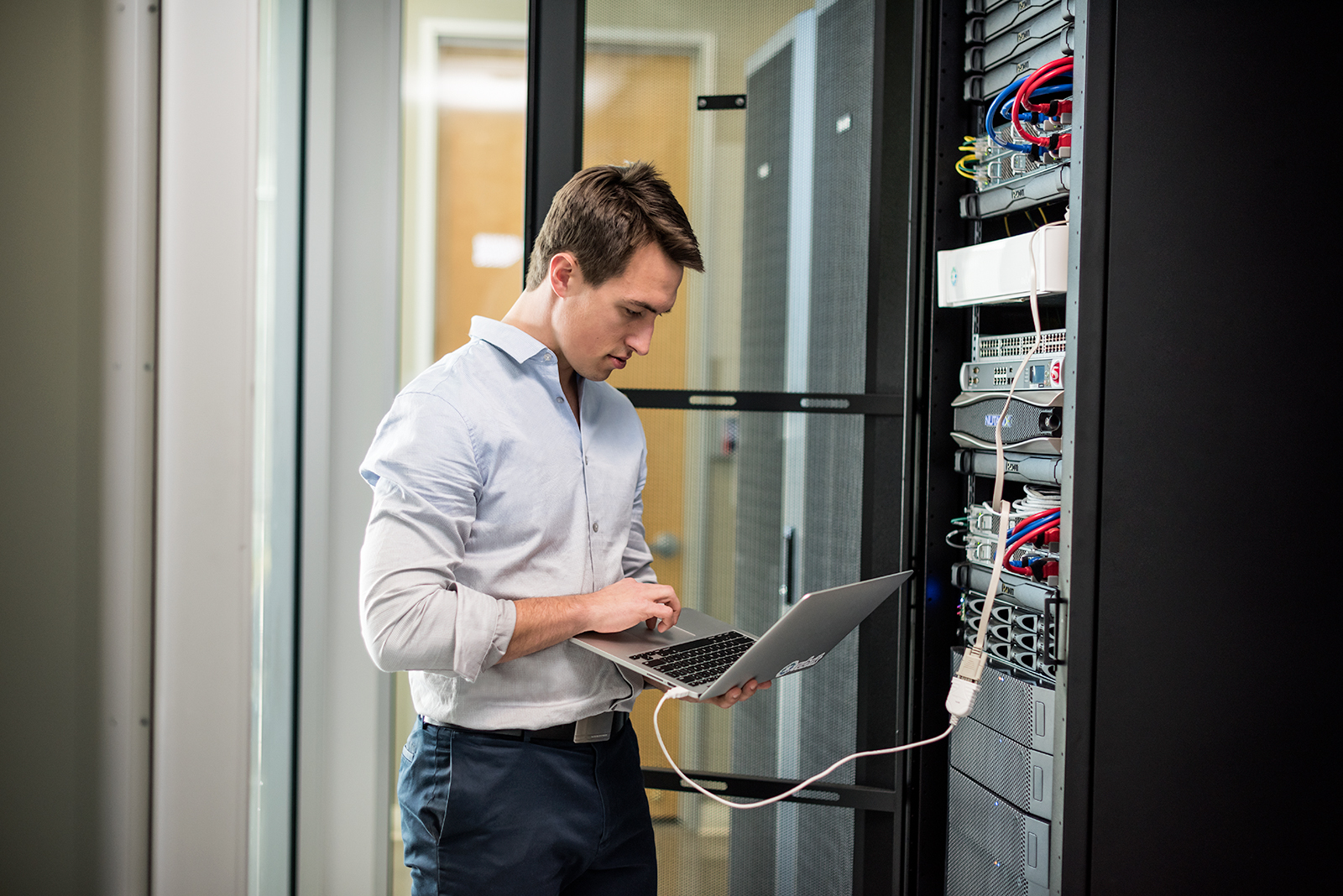 Young man working on computer in a data center