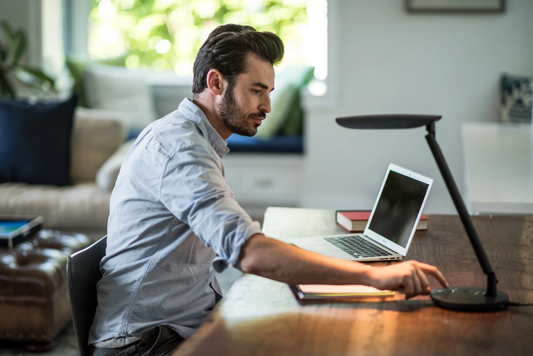 Man turning on a light while working at home