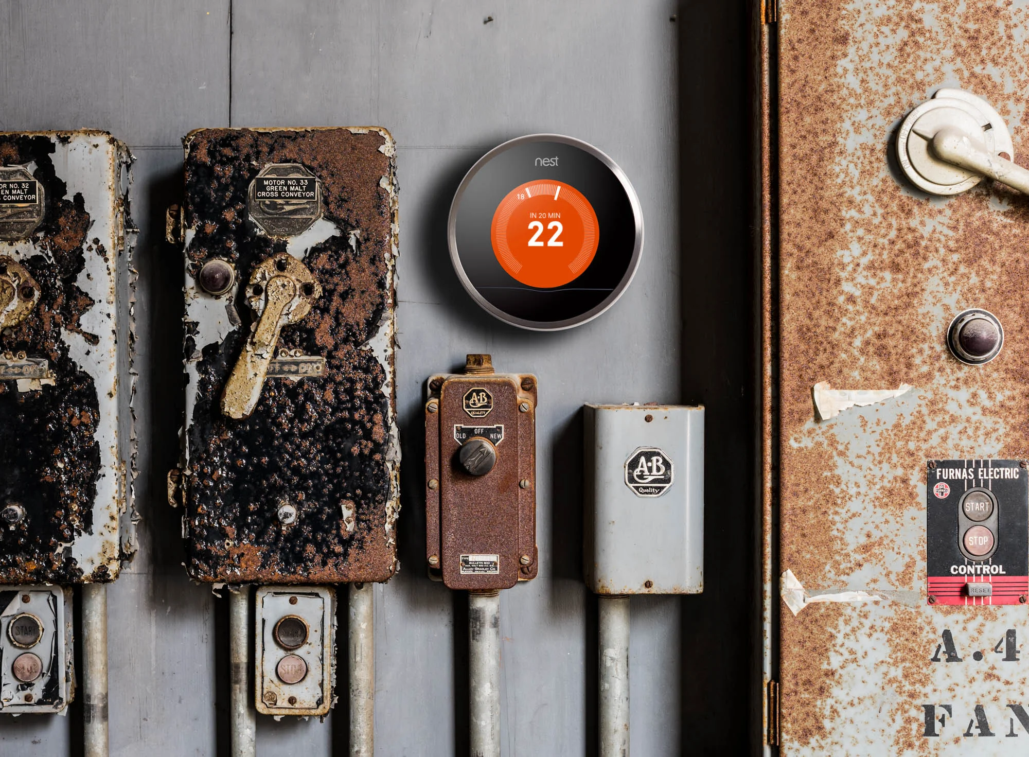 Nest thermostat on rusty wall