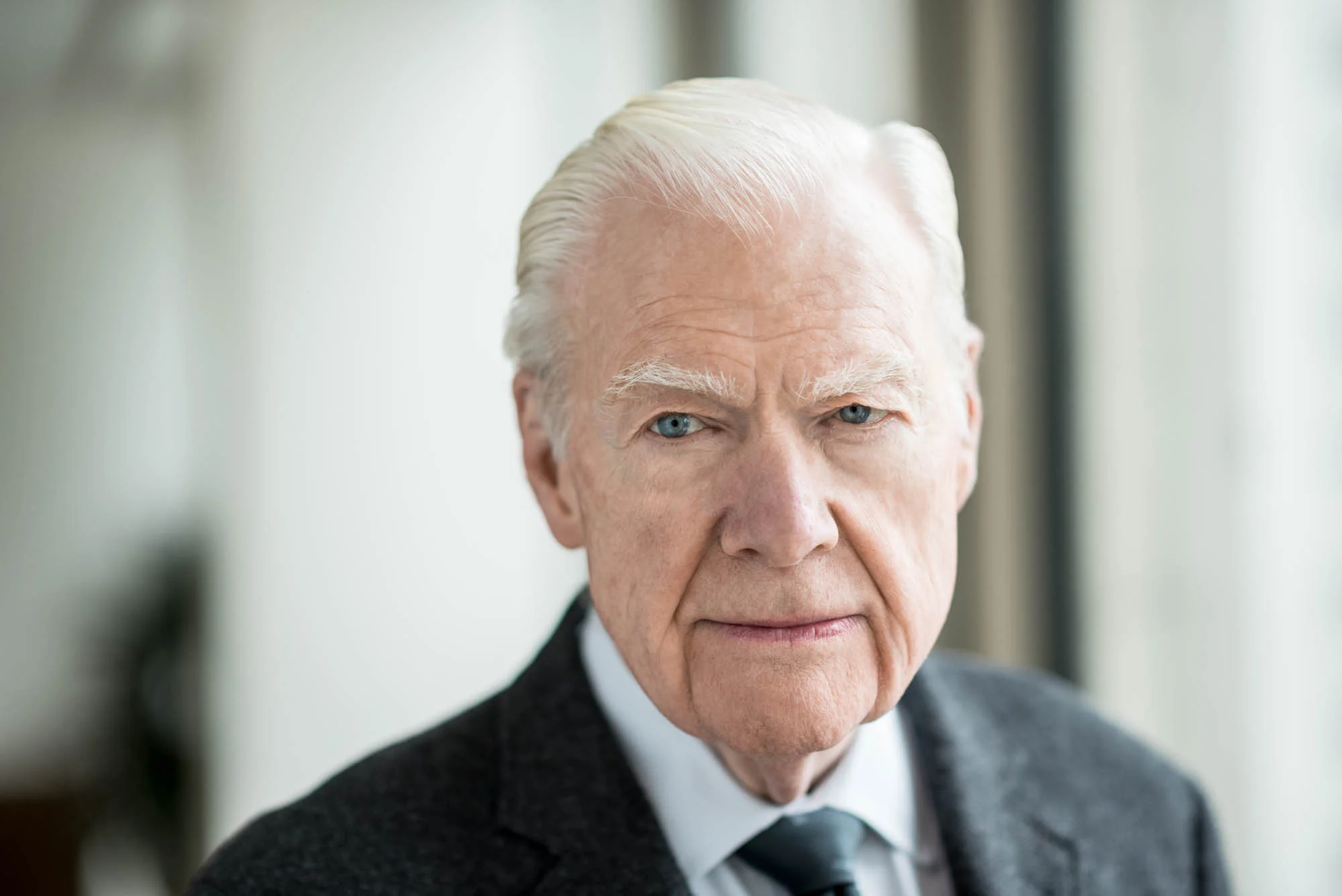 corporate portrait of an older man in professional business clothing