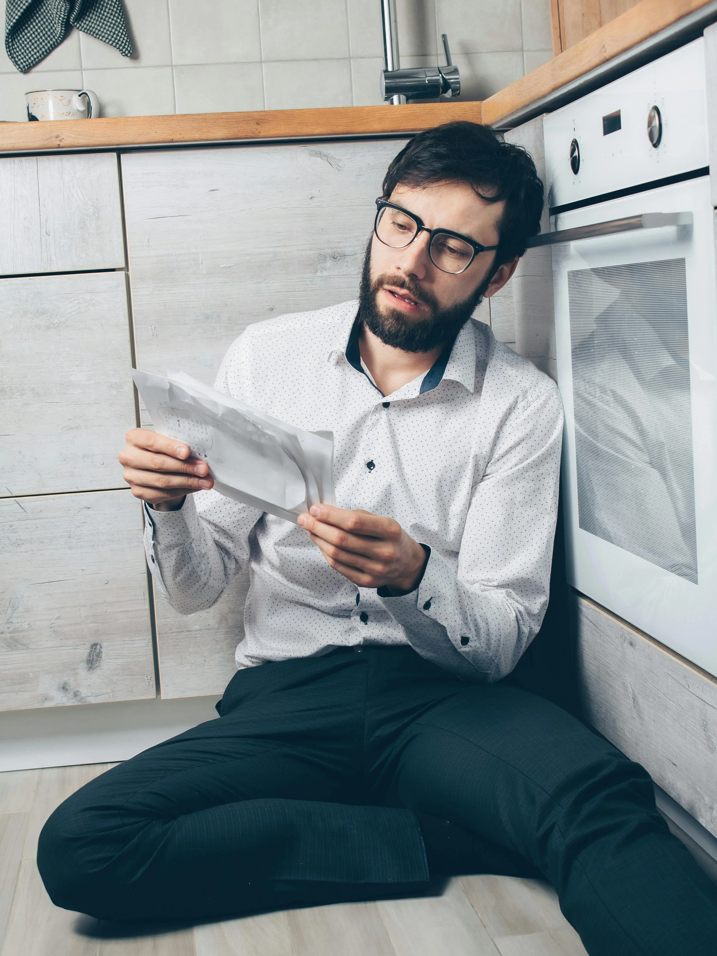 Homeowner reviewing an appliance manual to check safety instructions.