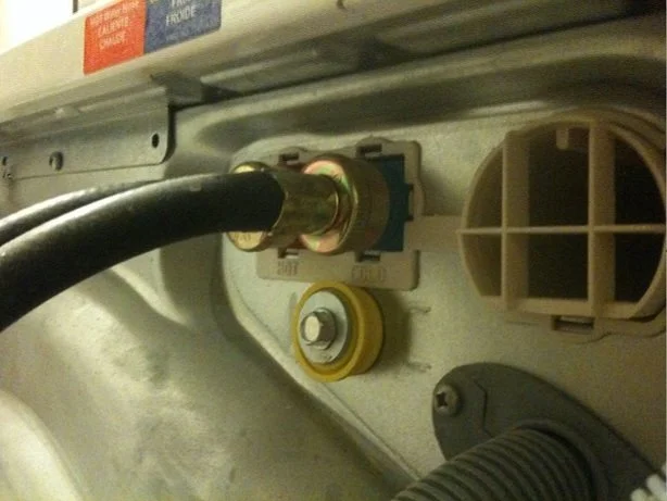 Homeowner inspecting washing machine for post-holiday wear