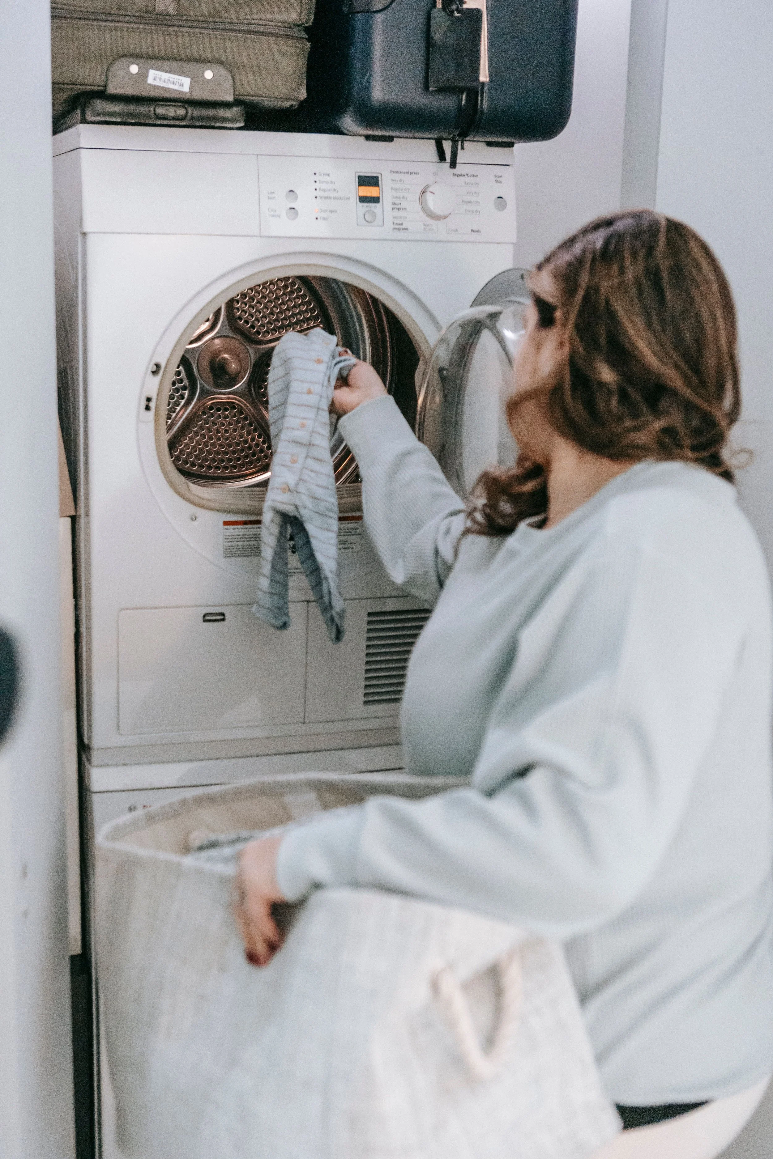 Clothes dryer operating in a residential laundry room during summer.