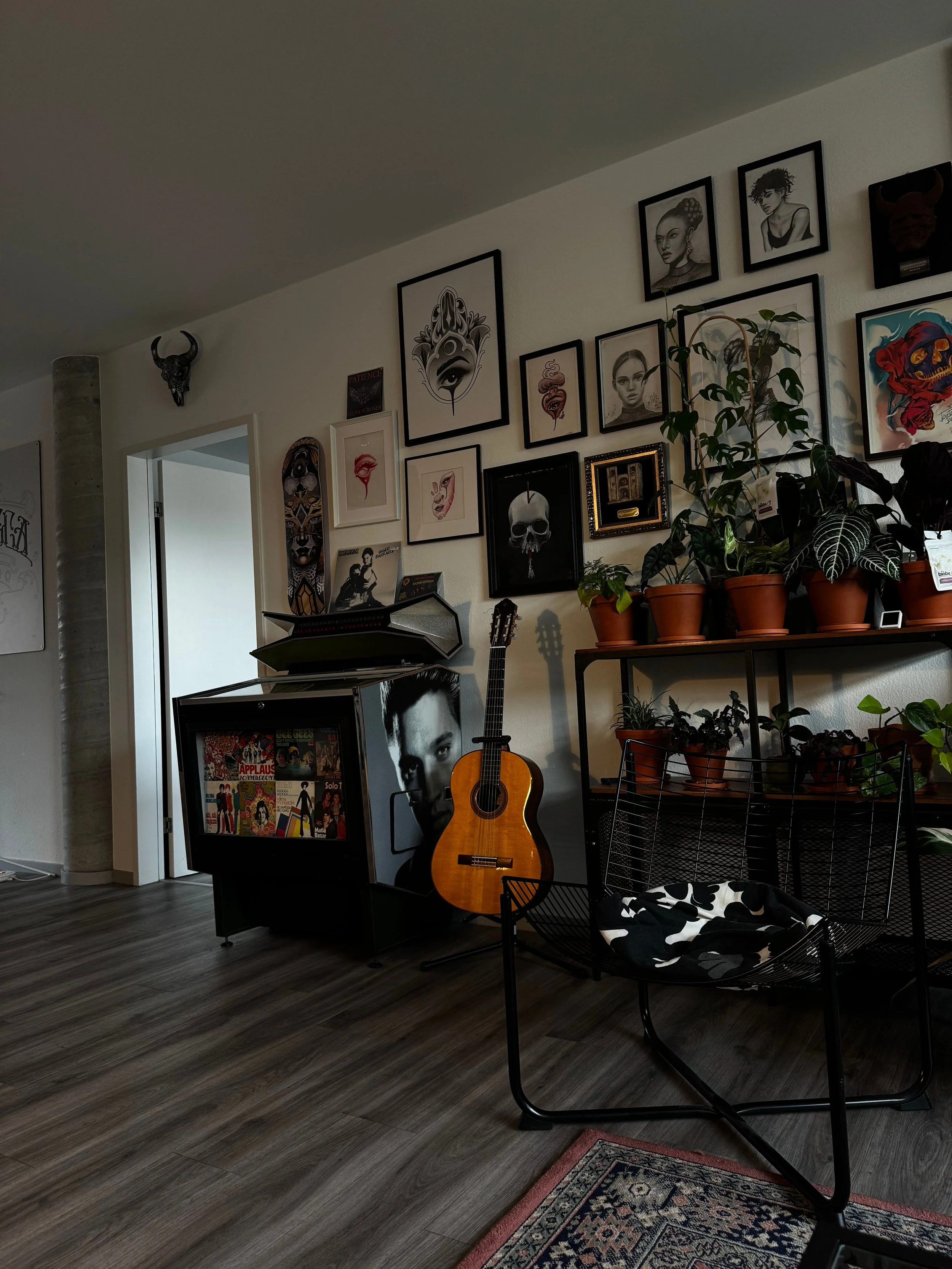 Gallery wall featuring framed artwork and family photographs in a contemporary living room.