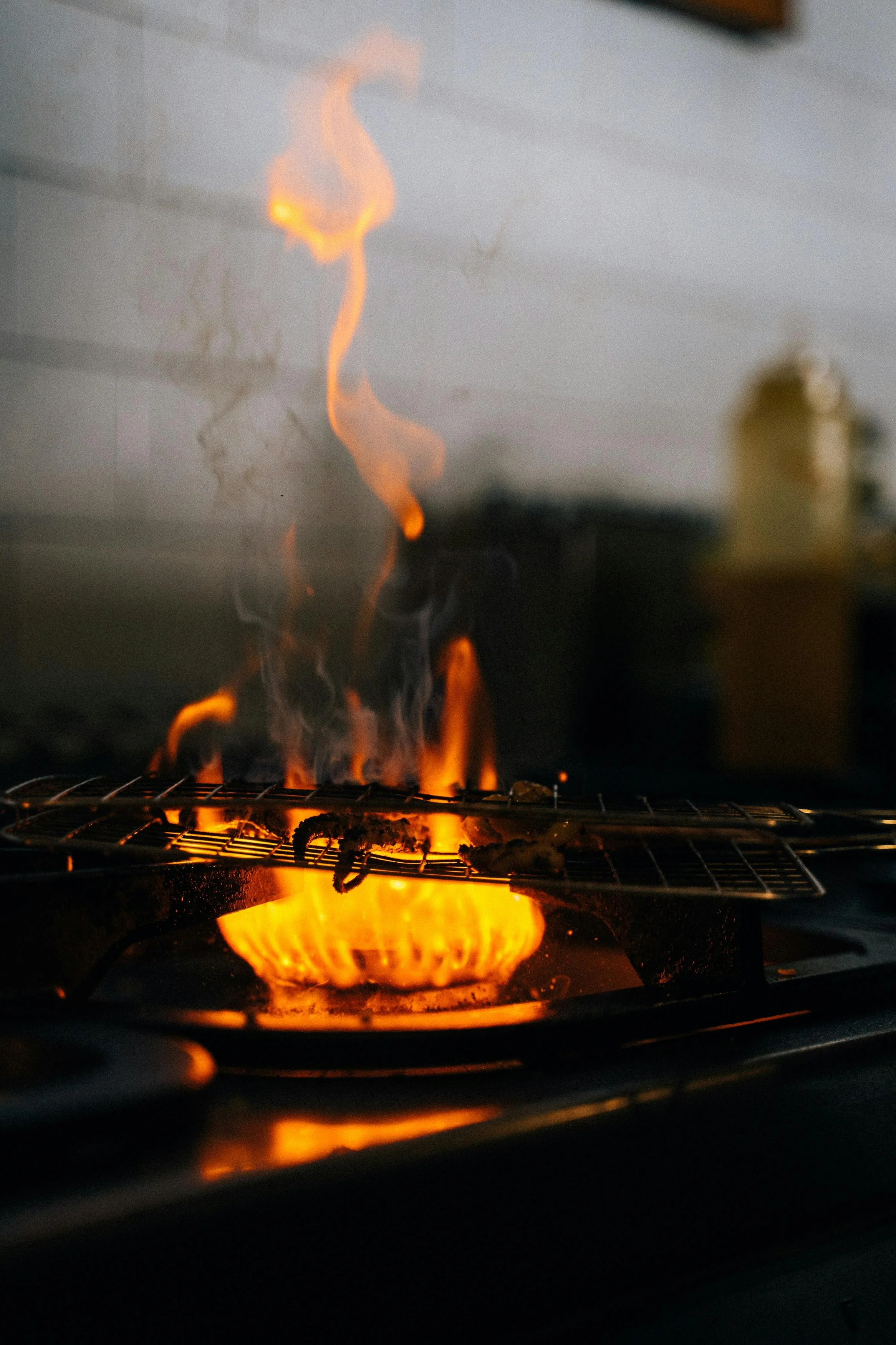 Uneven yellow flame on a gas stove burner indicating possible appliance issues