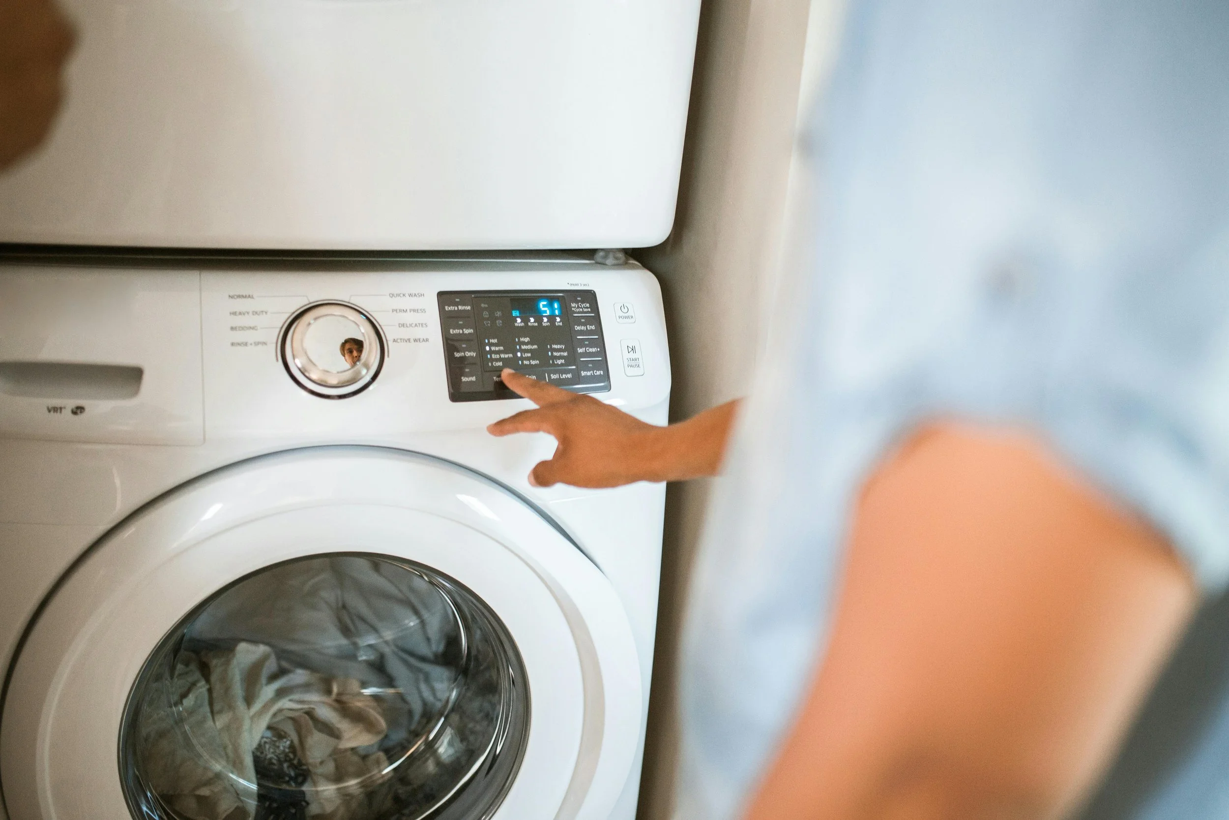 Modern home laundry room with washer and dryer in use