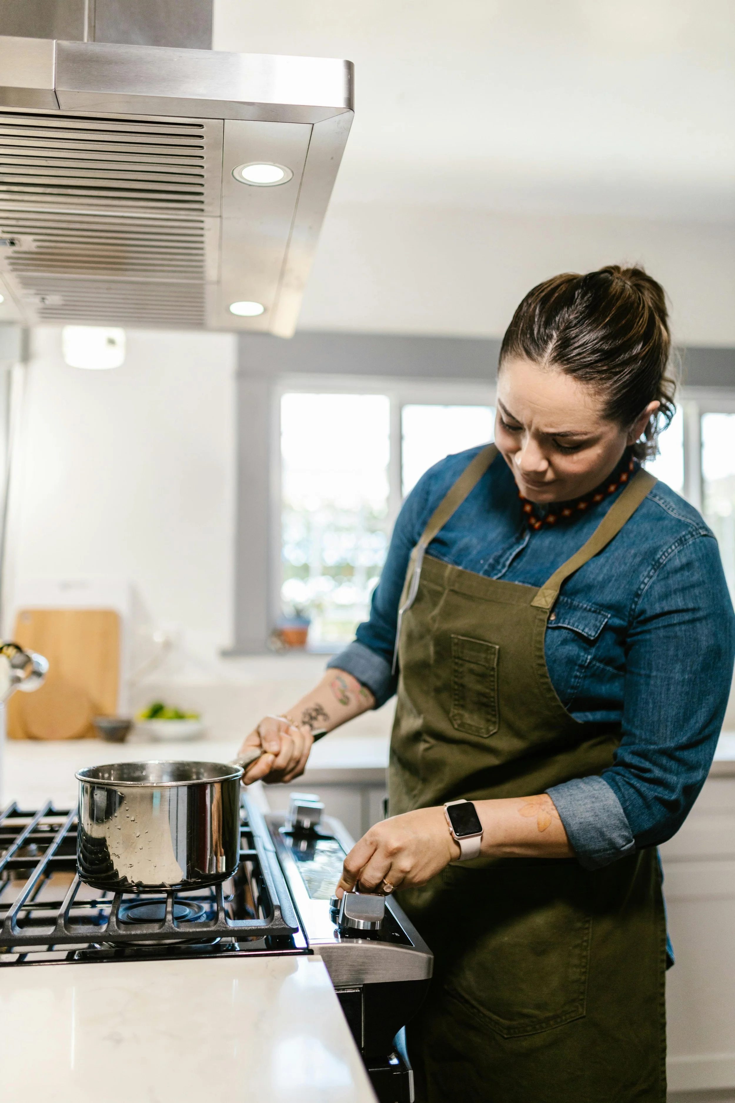 Homeowner inspecting a gas oven in a modern kitchen