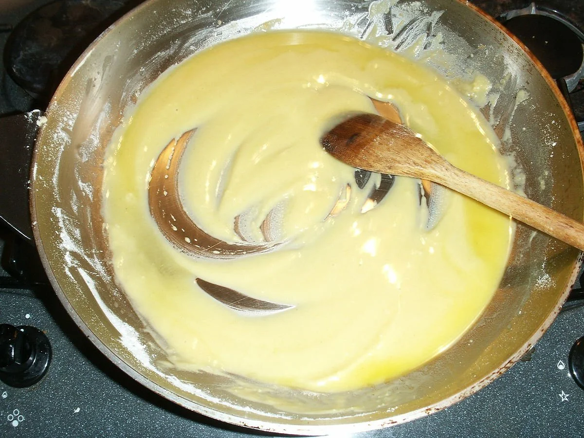  It needs to cook for a minute or so longer, but this is the color your bechemel should be.  