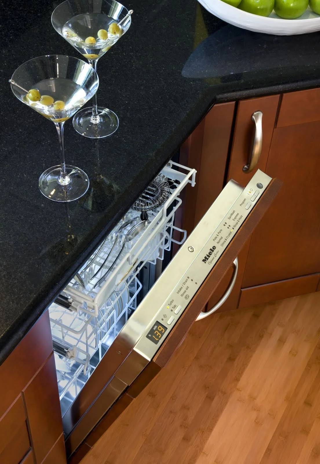  A fully integrated dishwasher in the kitchen, with the control panel shown off. You can’t see the cabinetry panel as well, but you can see the drawer pull and the staining of the panel which match others within the kitchen.  