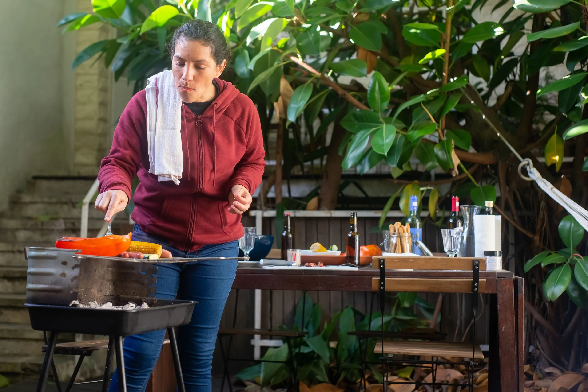 Homeowner grilling outdoors during a summer cookout"