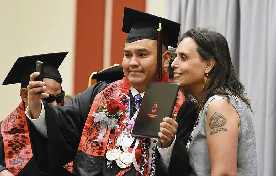 Navajo Times | Donovan Quintero A Navajo Technical University graduate takes a selfie with guest speaker Winona LaDuke at the university's commencement last Friday.