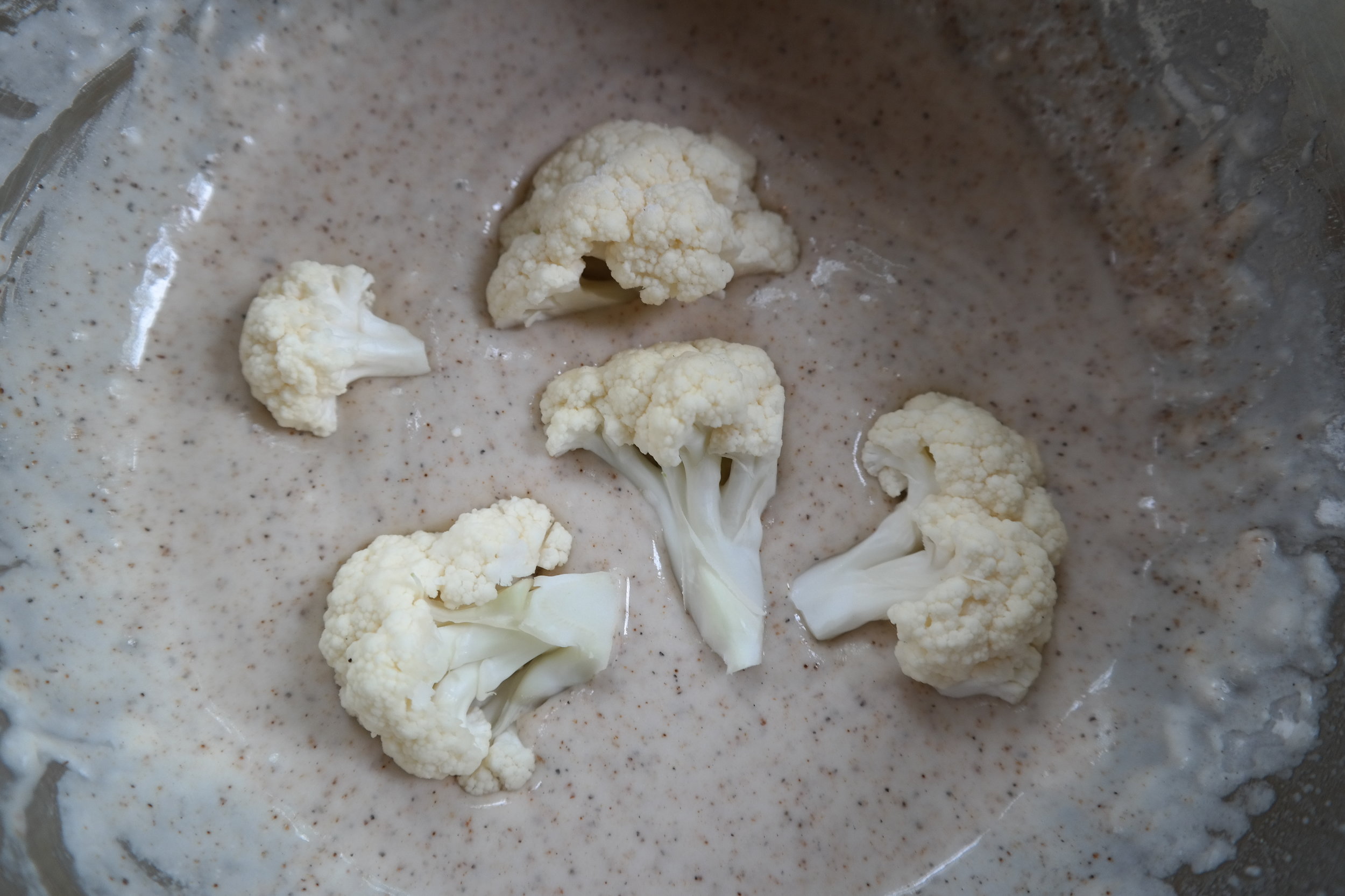 Coat the cauliflower for baking 
