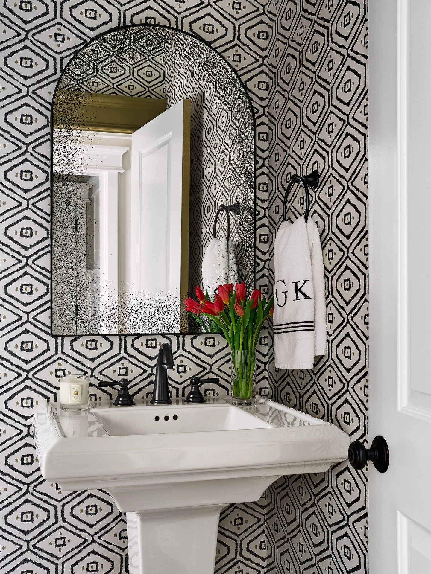 One of my favorite things about shooting small spaces is the challenge of capturing their full personality without overwhelming the shot. In this powder room, the geometric wallpaper and aged patina on the mirror definitely needed some directional li
