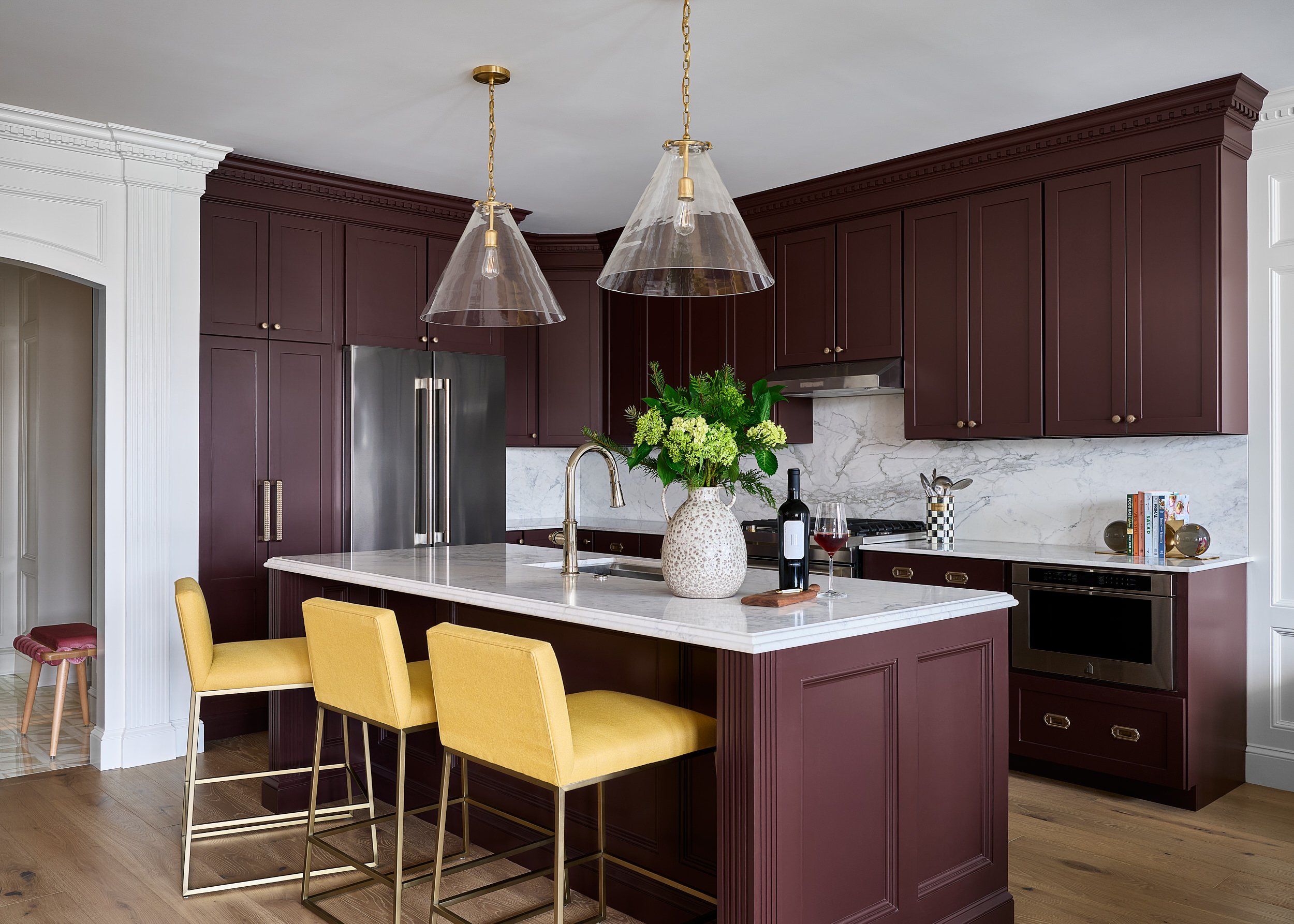 Kitchen with burgundy cabinetry and yellow leather counter stools, interior design photography in Washington, DC