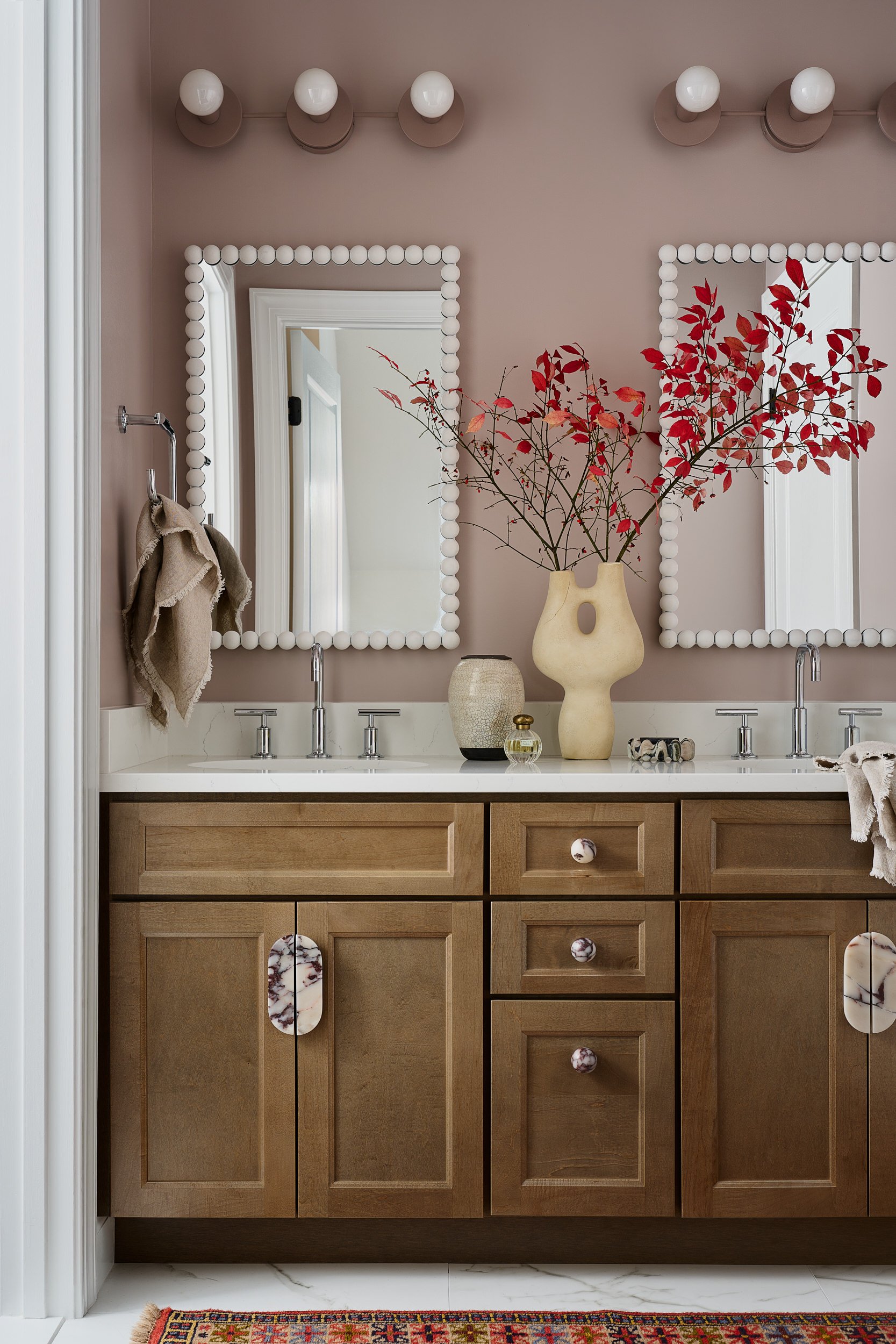 Bathroom double vanity with mauve walls and beaded mirrors, interior design photography in the DMV area