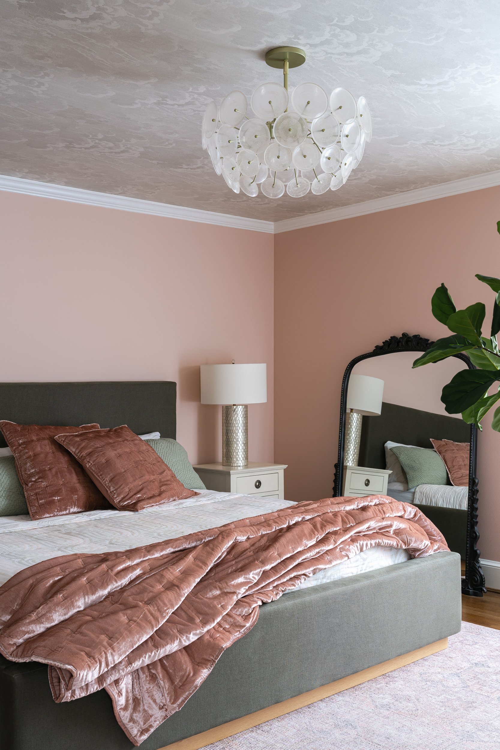 Bedroom with blush pink walls and velvet bedding, interior design photography in the DMV area