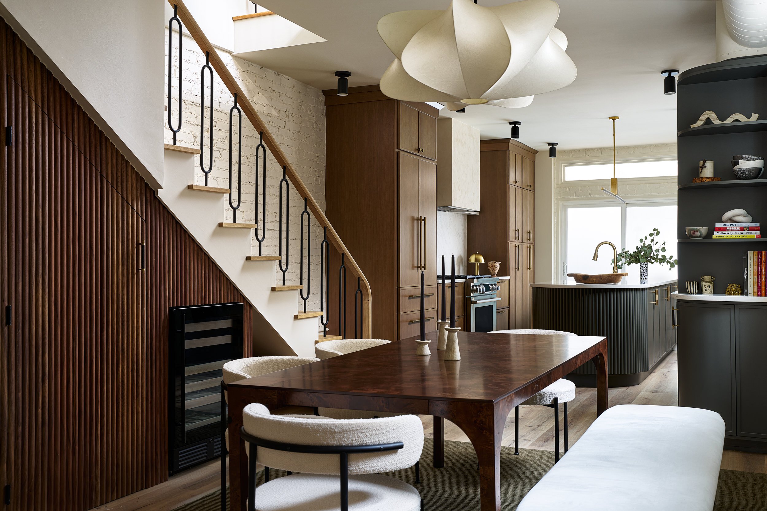 Open-concept dining and kitchen area with a sculptural pendant light, interior design photography in the DMV area