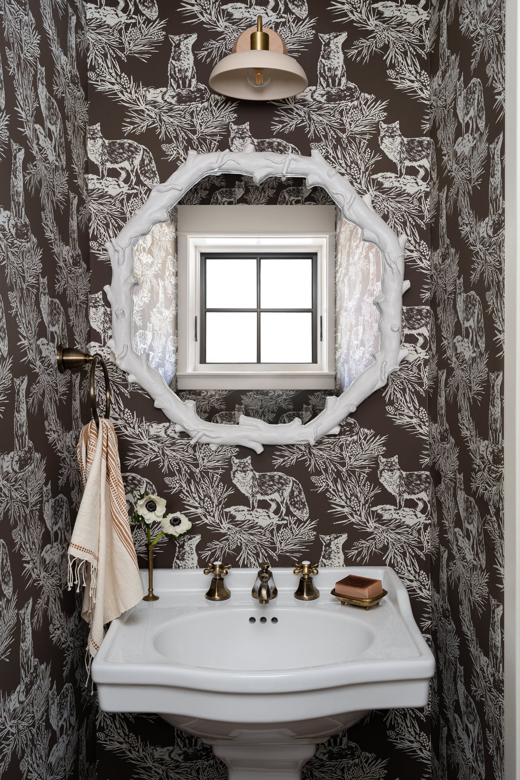 Powder room with animal print wallpaper and a white mirror, interior design photography in the DMV area