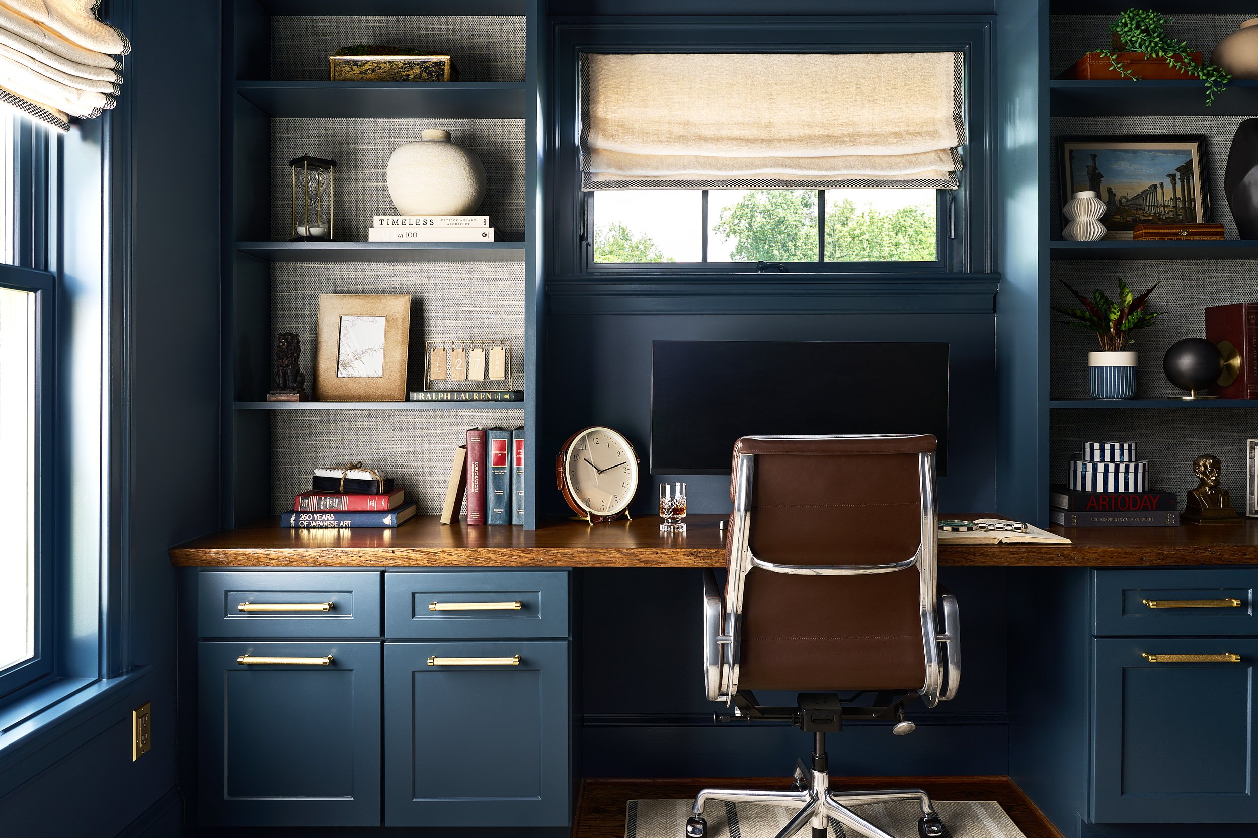 Home office with navy built-in cabinetry and a wood desktop, interior design photography in Northern Virginia