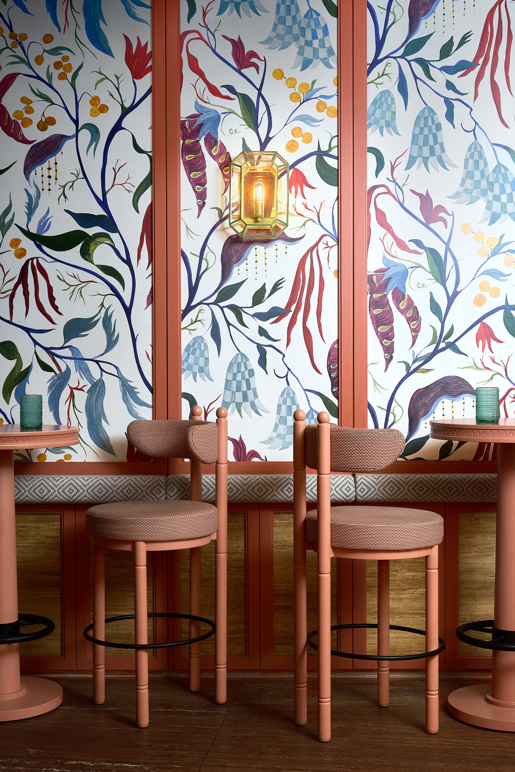 Restaurant dining room with floral wallpaper and banquette seating, commercial interior photography in the DMV area