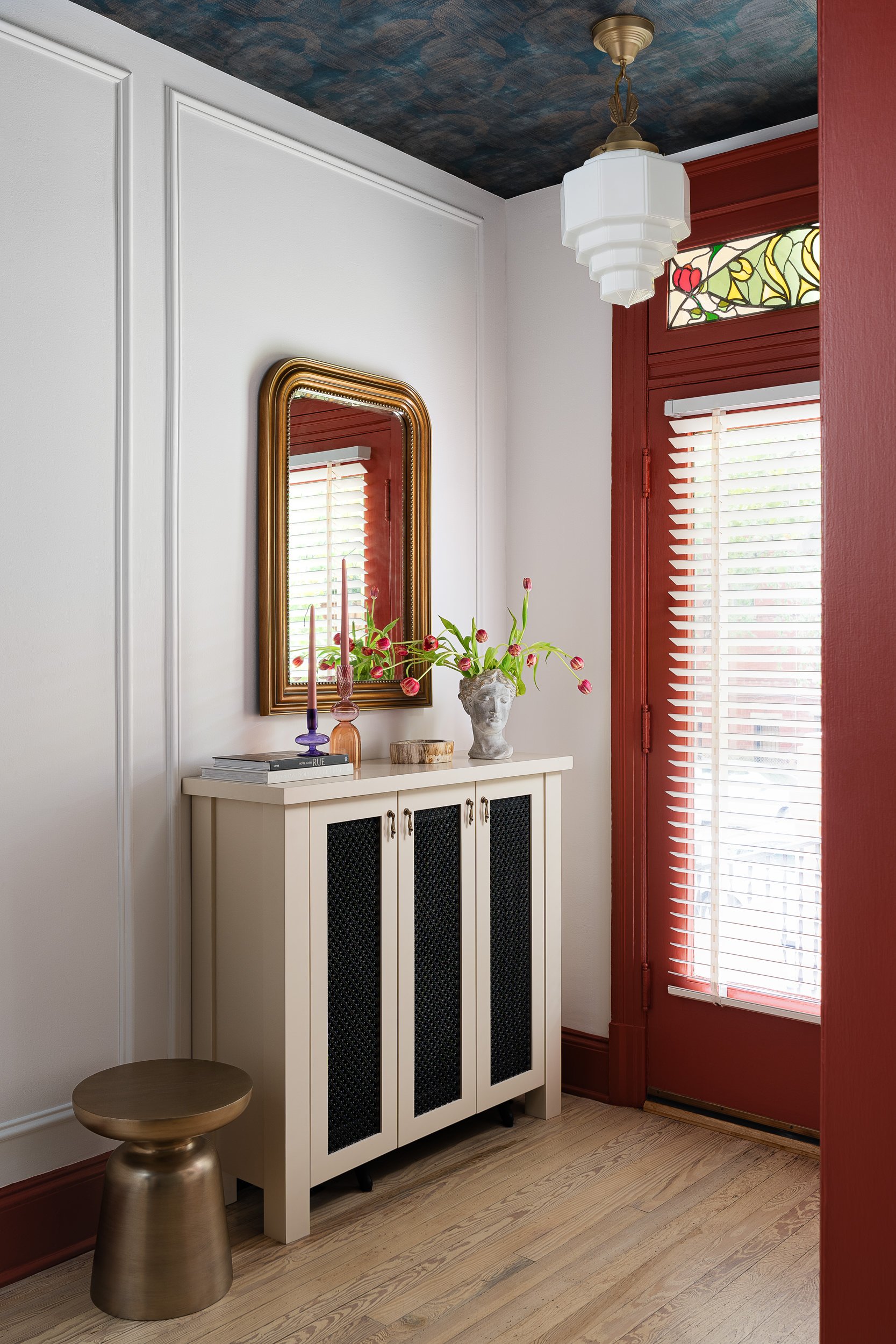 Entryway with dark ceiling wallpaper and a stained glass transom, interior design photography in the DMV area