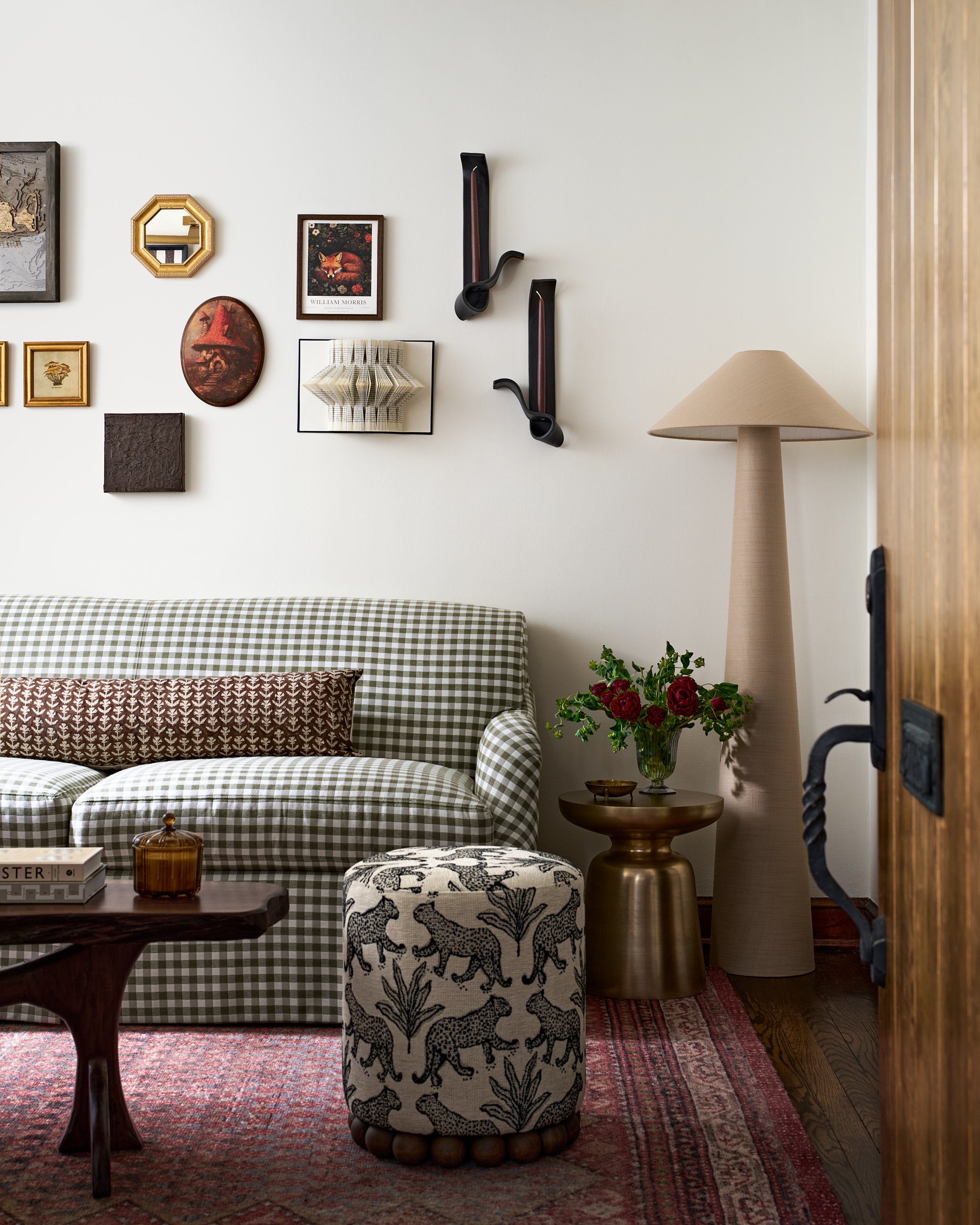 Living room with a gingham sofa and eclectic gallery wall, interior design photography in Washington, DC