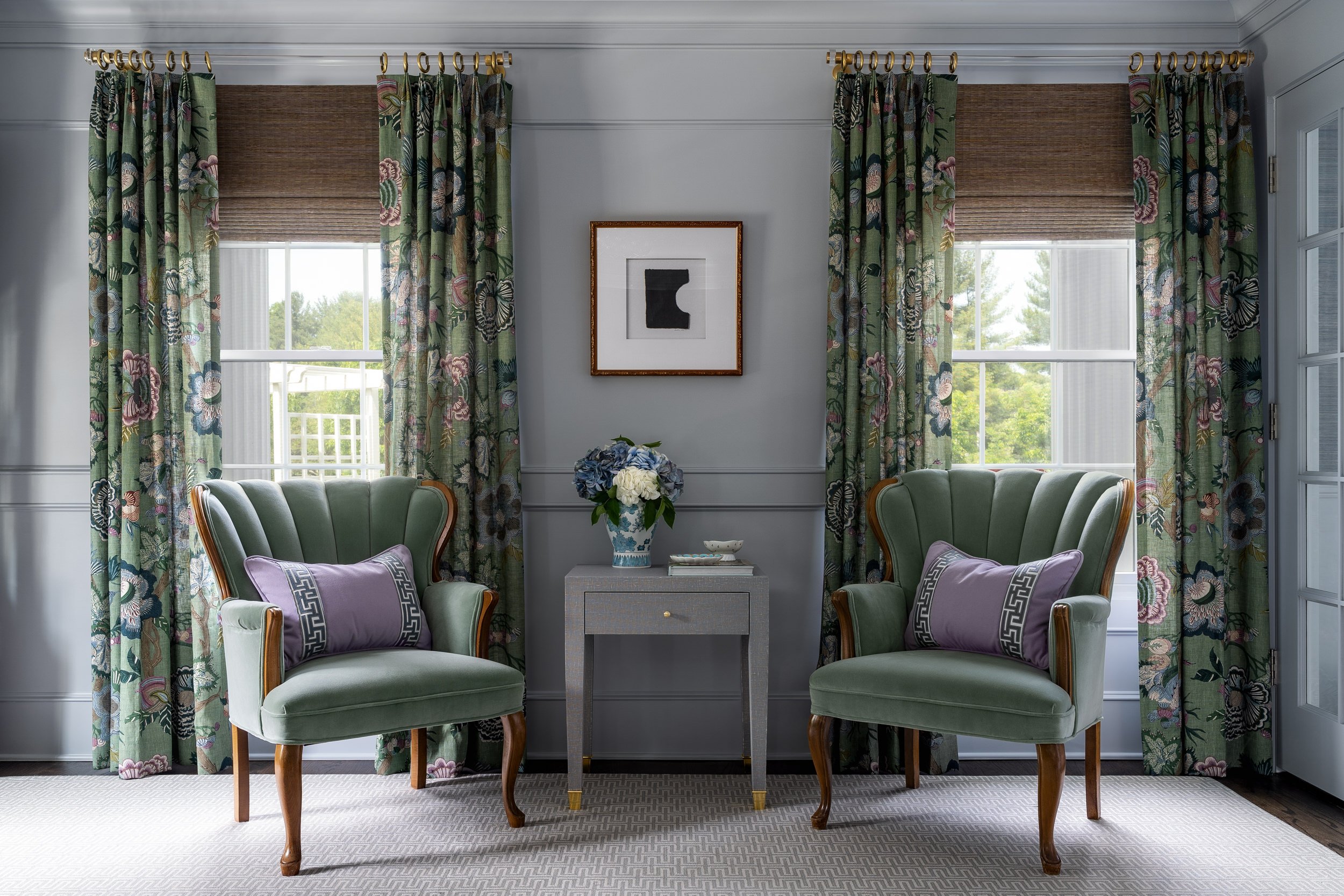 Sitting area with scalloped green velvet chairs and floral drapery, interior design photography in Northern Virginia
