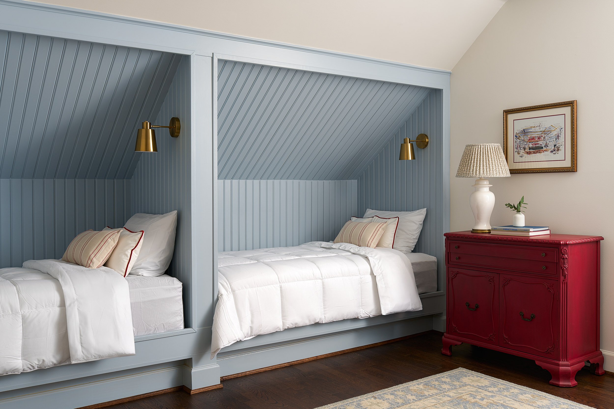 Bunk room with blue built-in beds and a red vintage dresser, interior design photography in the DMV area