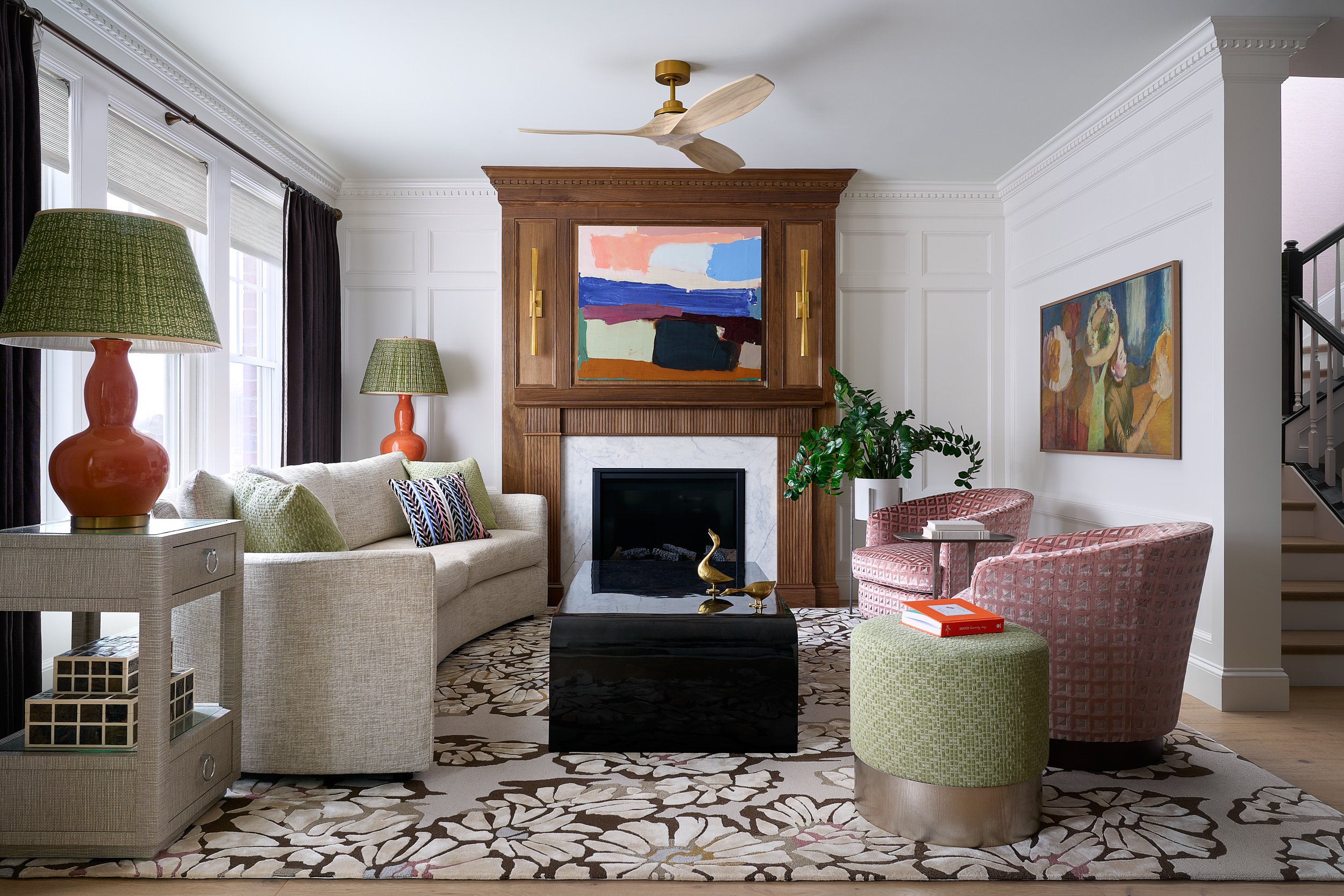 Living room with a curved sofa and floral area rug, interior design photography in Maryland