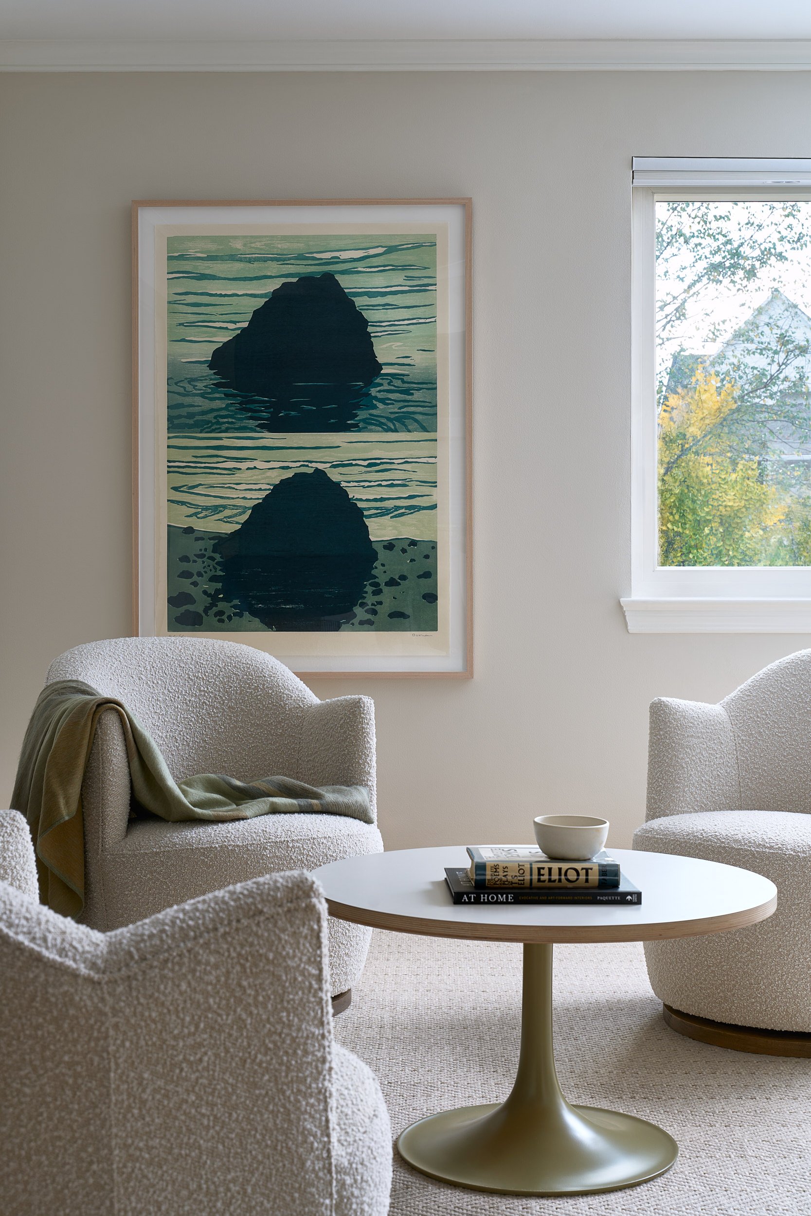 Living room with bouclé armchairs and framed art, interior design photography in Northern Virginia