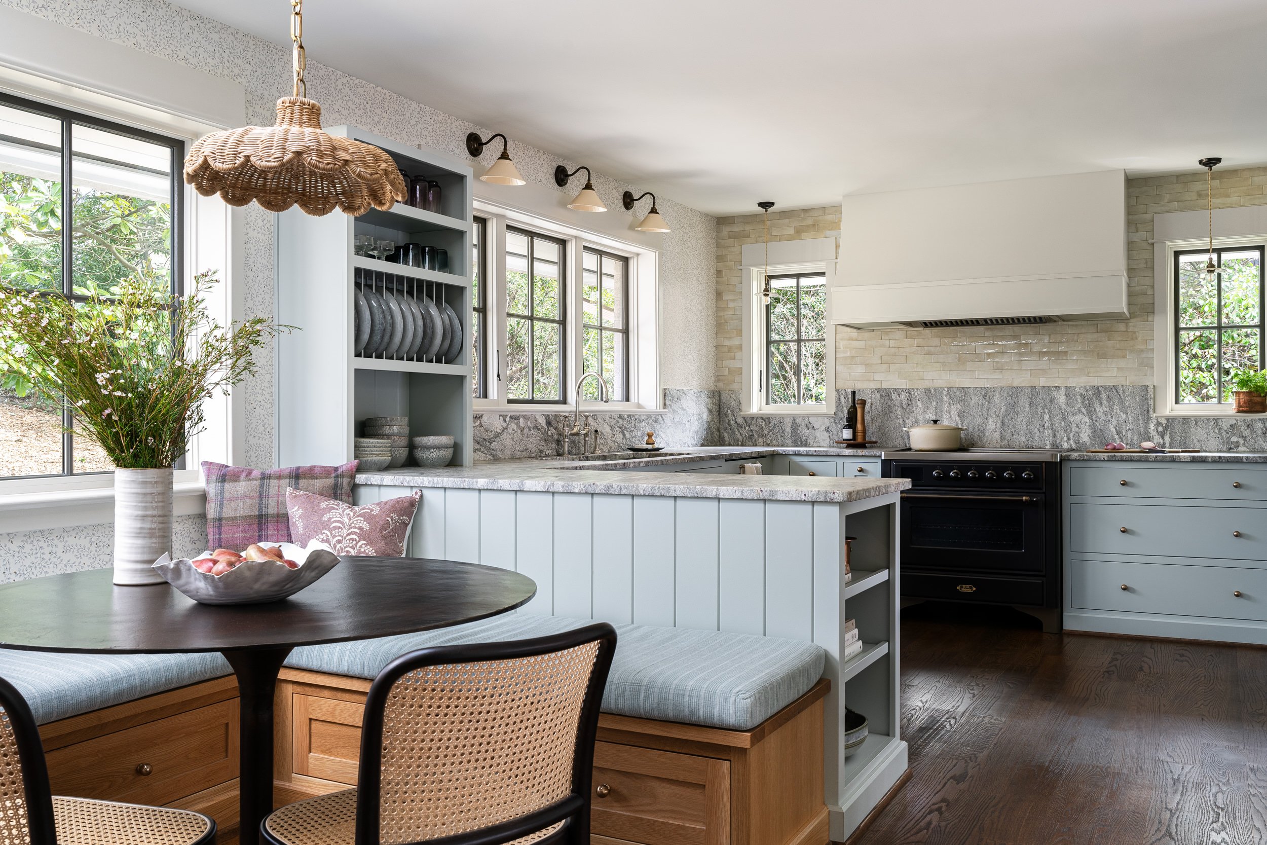Kitchen breakfast nook with light blue cabinetry and a rattan pendant, interior design photography in Washington, DC