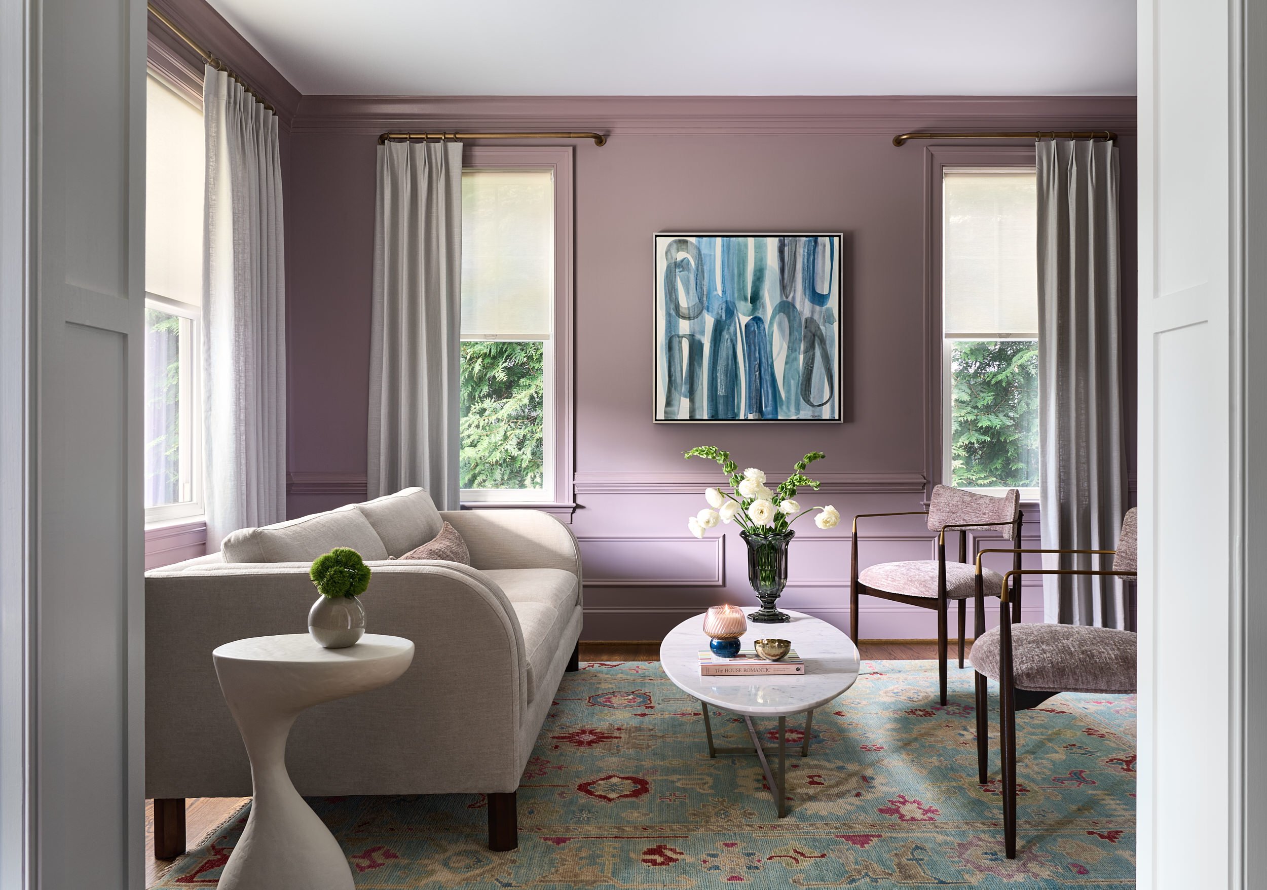 Living room with mauve walls and framed blue artwork, interior design photography in Washington, DC