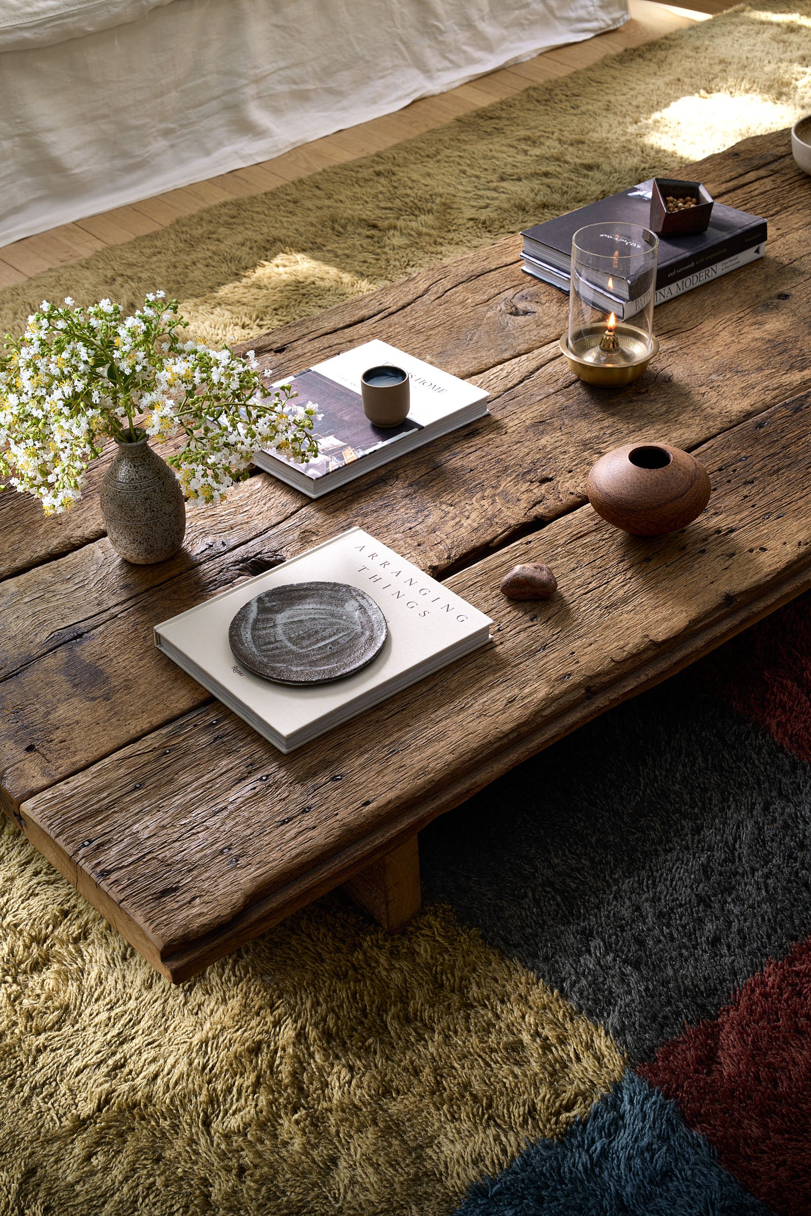 Coffee table styling on a rustic reclaimed wood table, interior design photography in the DMV area