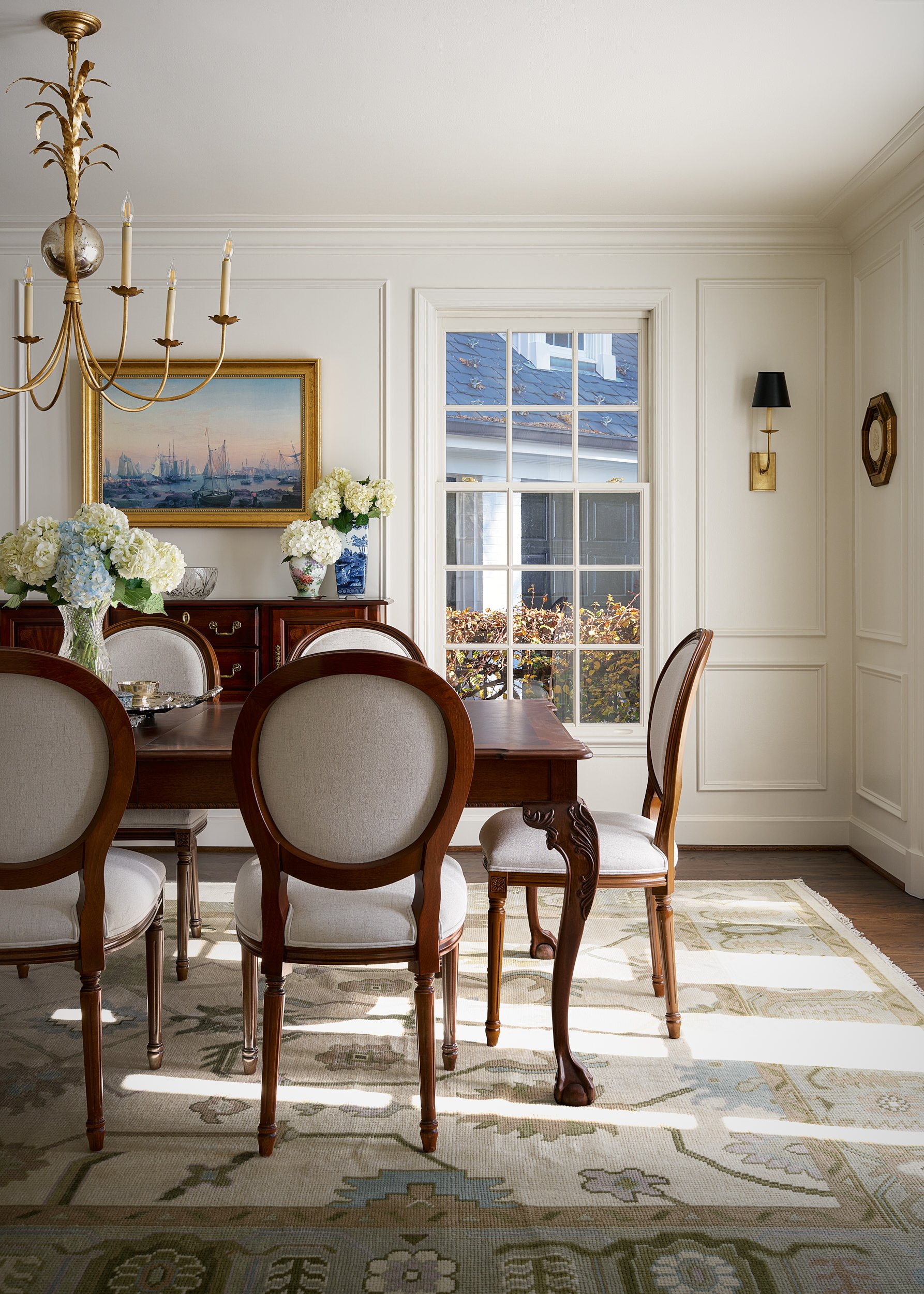 Traditional dining room with a gold chandelier, interior design photography in Maryland