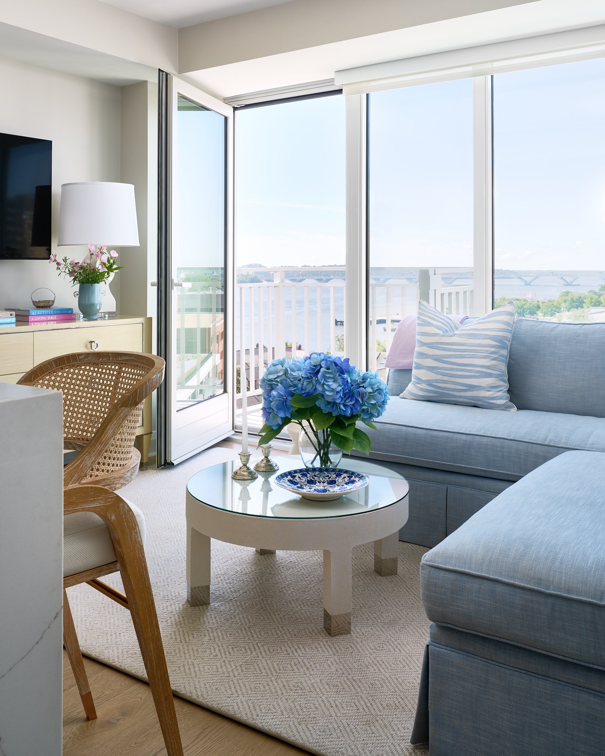 Condo living room with a private balcony and waterfront view, interior design photography in Maryland