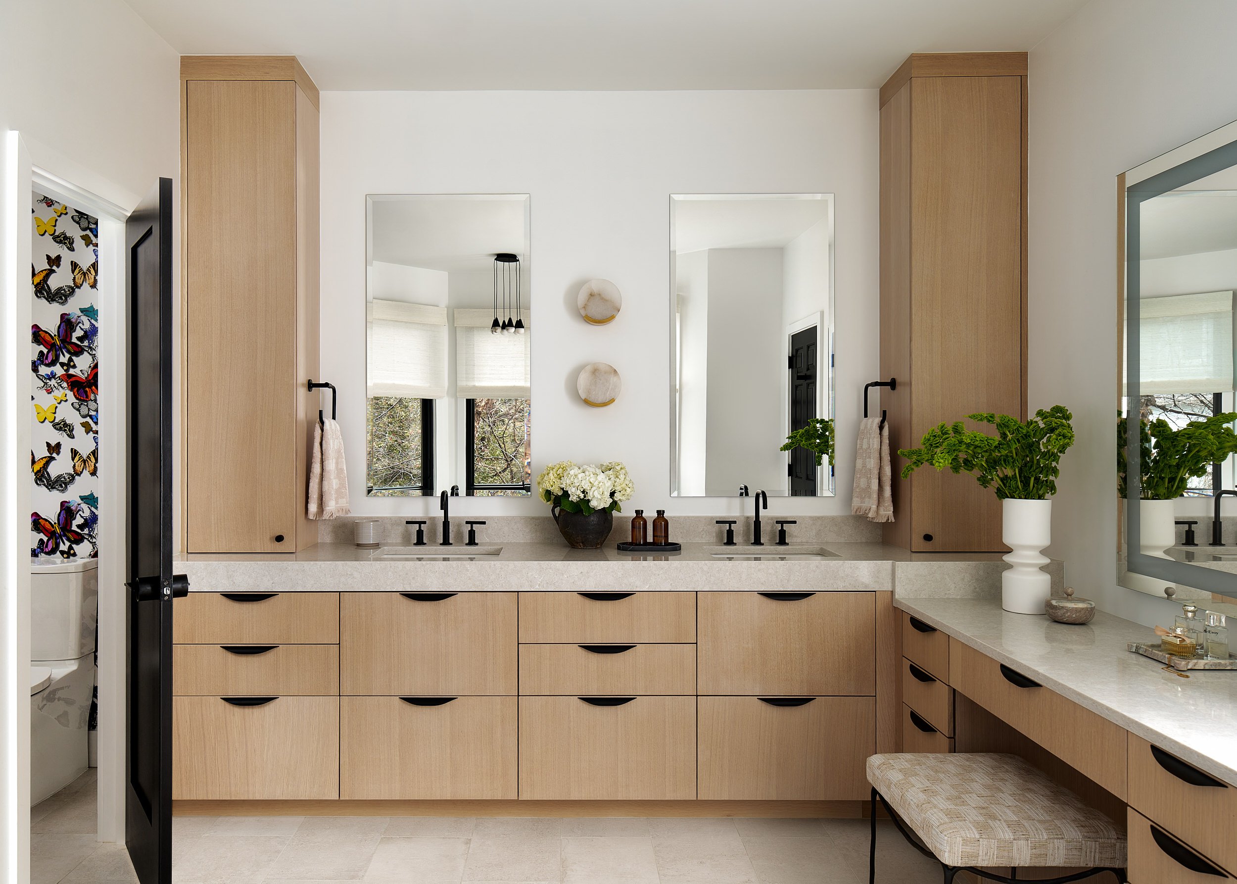 Primary bathroom with a white oak double vanity and matte black hardware, interior design photography in the DMV area