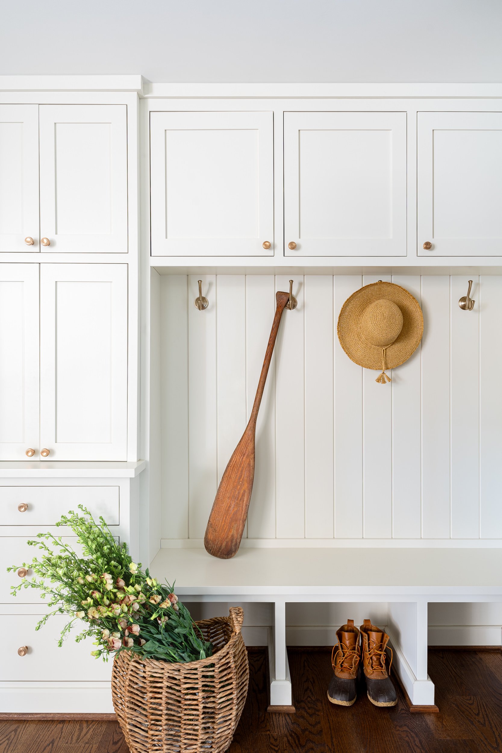 Mudroom with white built-in cabinetry and bench seating, interior design photography in Washington, DC