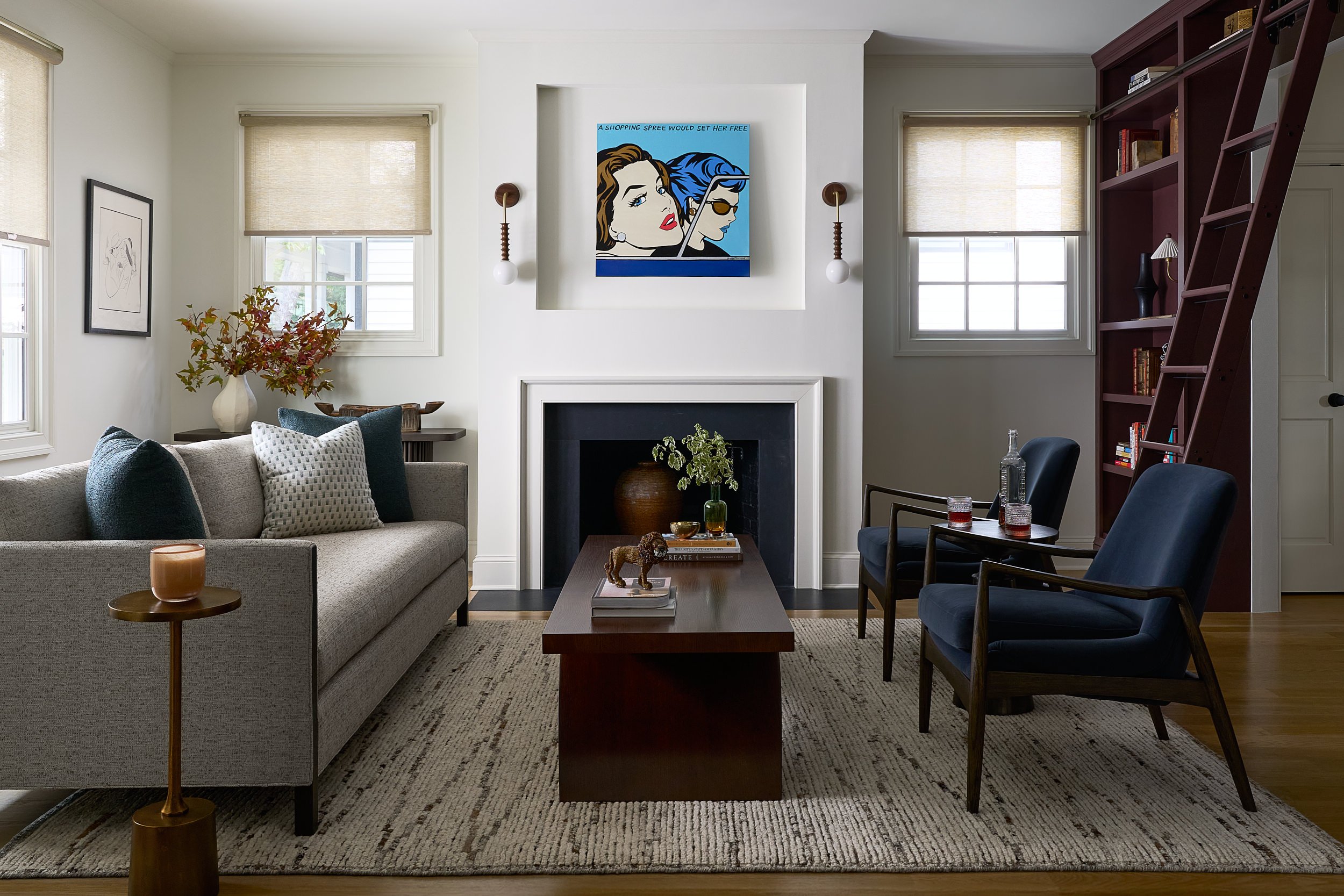 Living room with navy accent chairs, a fireplace, and a pop art painting, interior design photography in Maryland