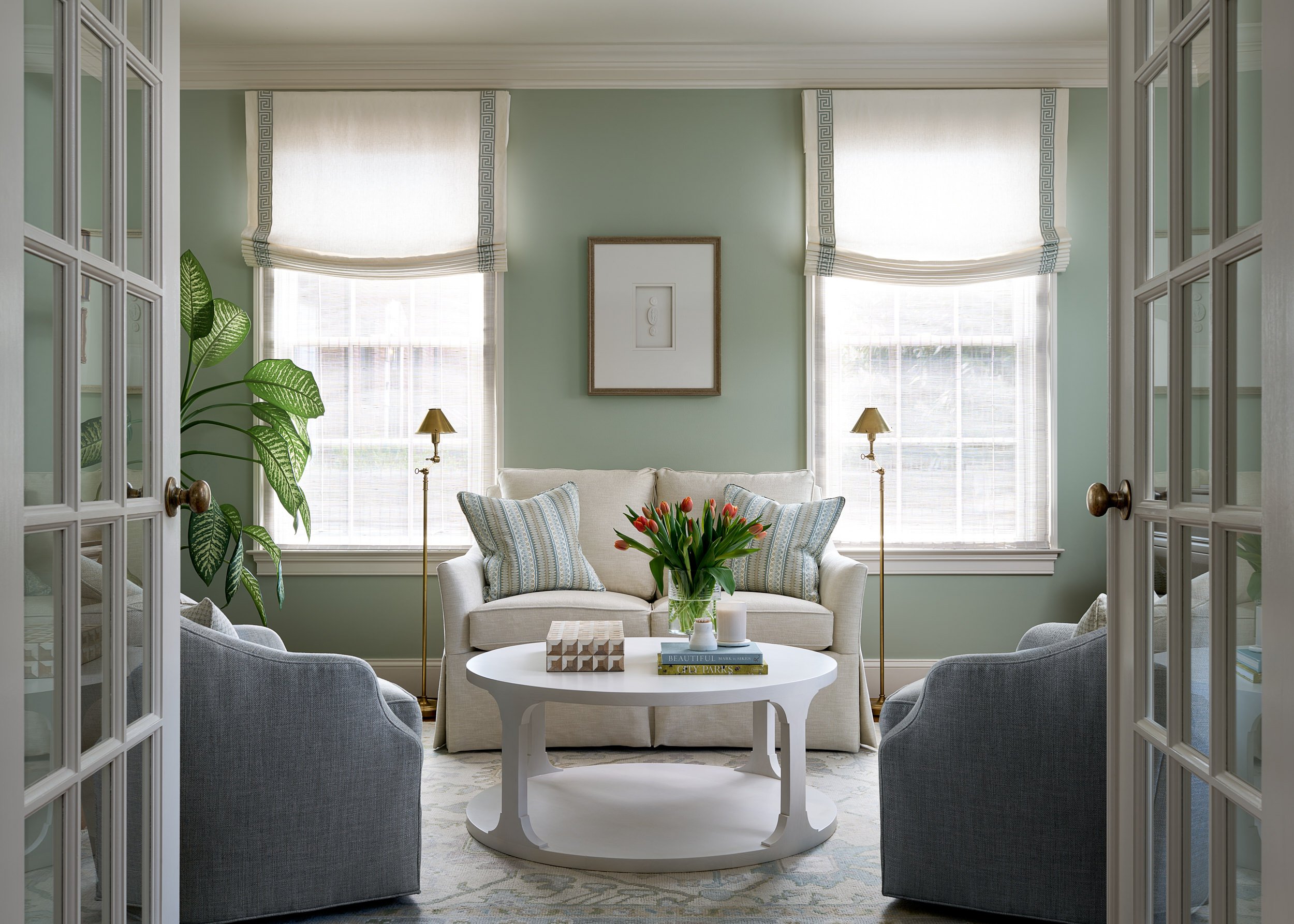 Sitting room with sage green walls and French doors, interior design photography in Maryland