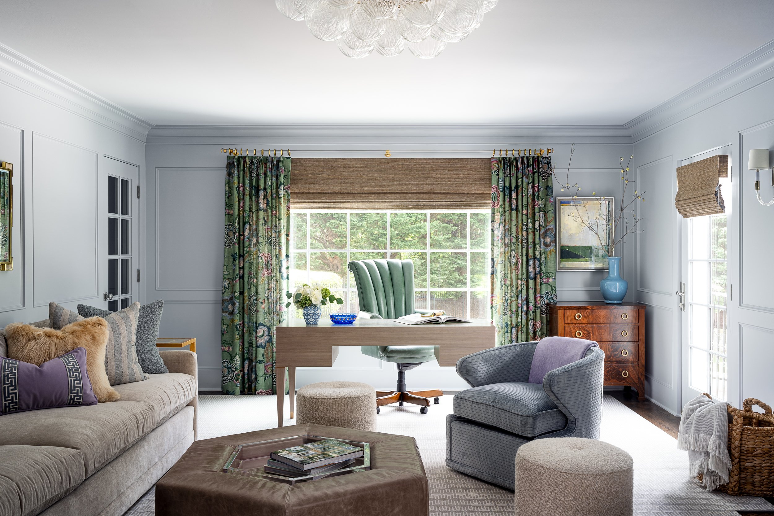 Living room sitting area with floral drapery opening to a home office nook, interior design photography in Washington, DC
