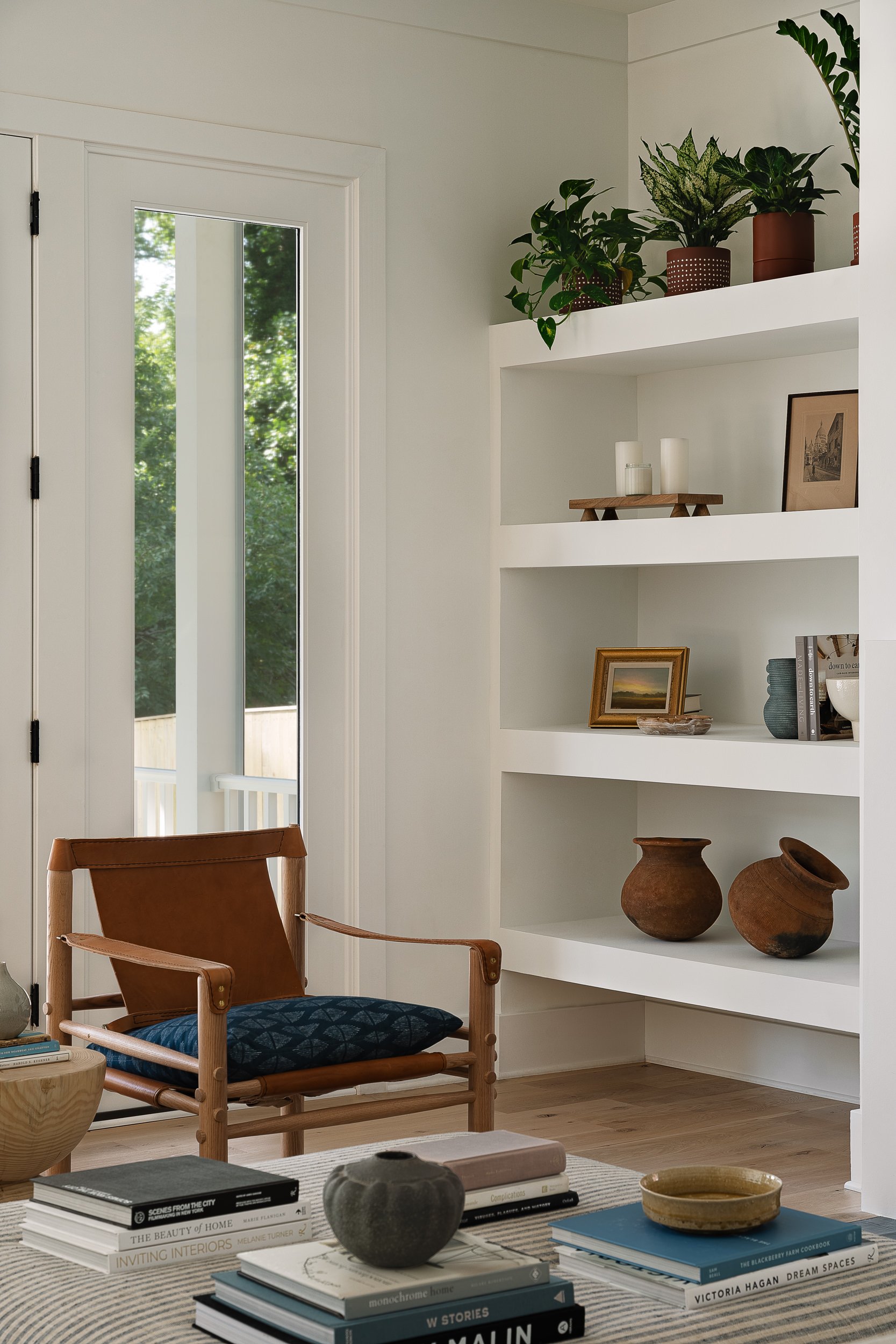 Living room corner with a leather armchair and built-in shelving, interior design photography in Northern Virginia