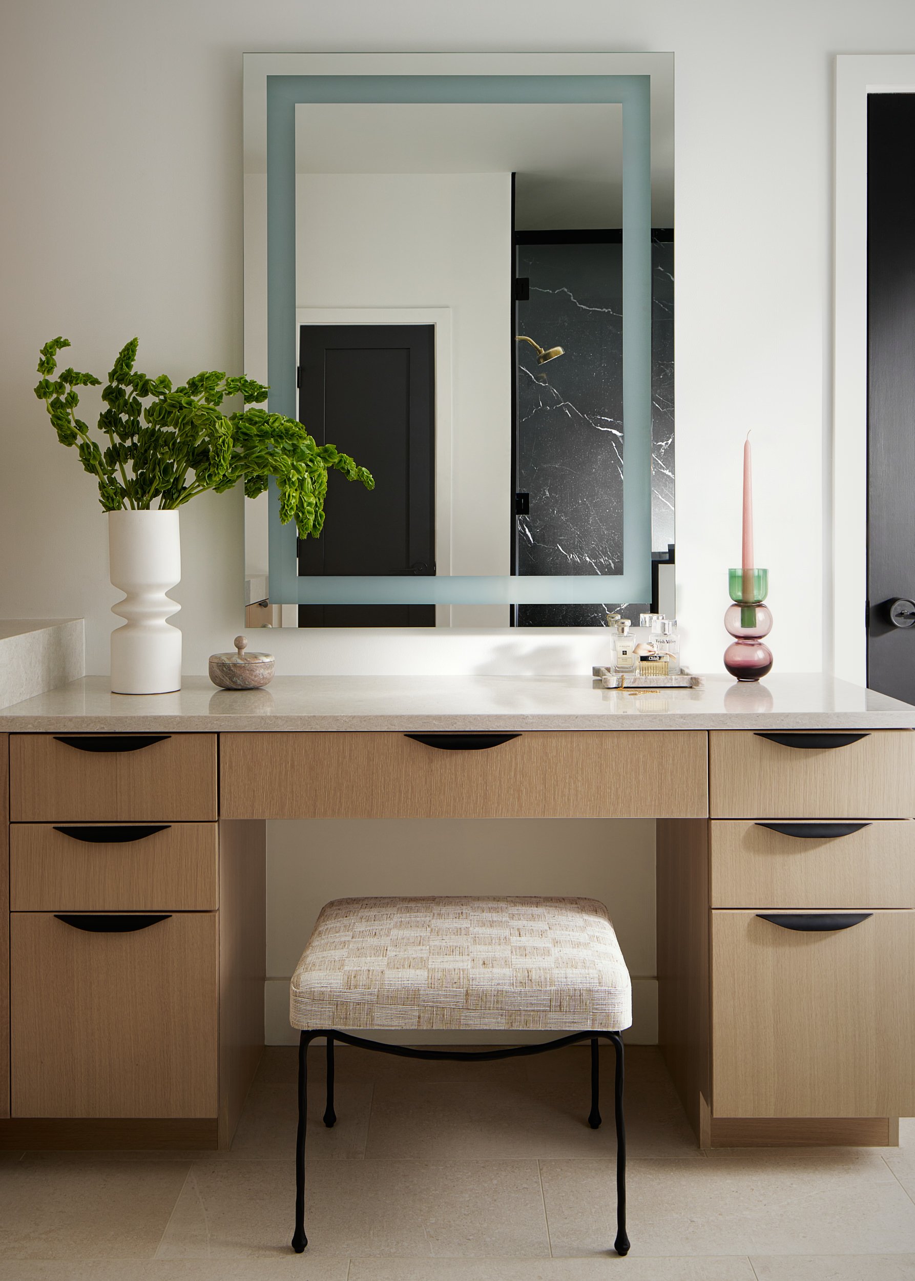 Bathroom vanity with a blue framed mirror and wood cabinetry, interior design photography in Maryland