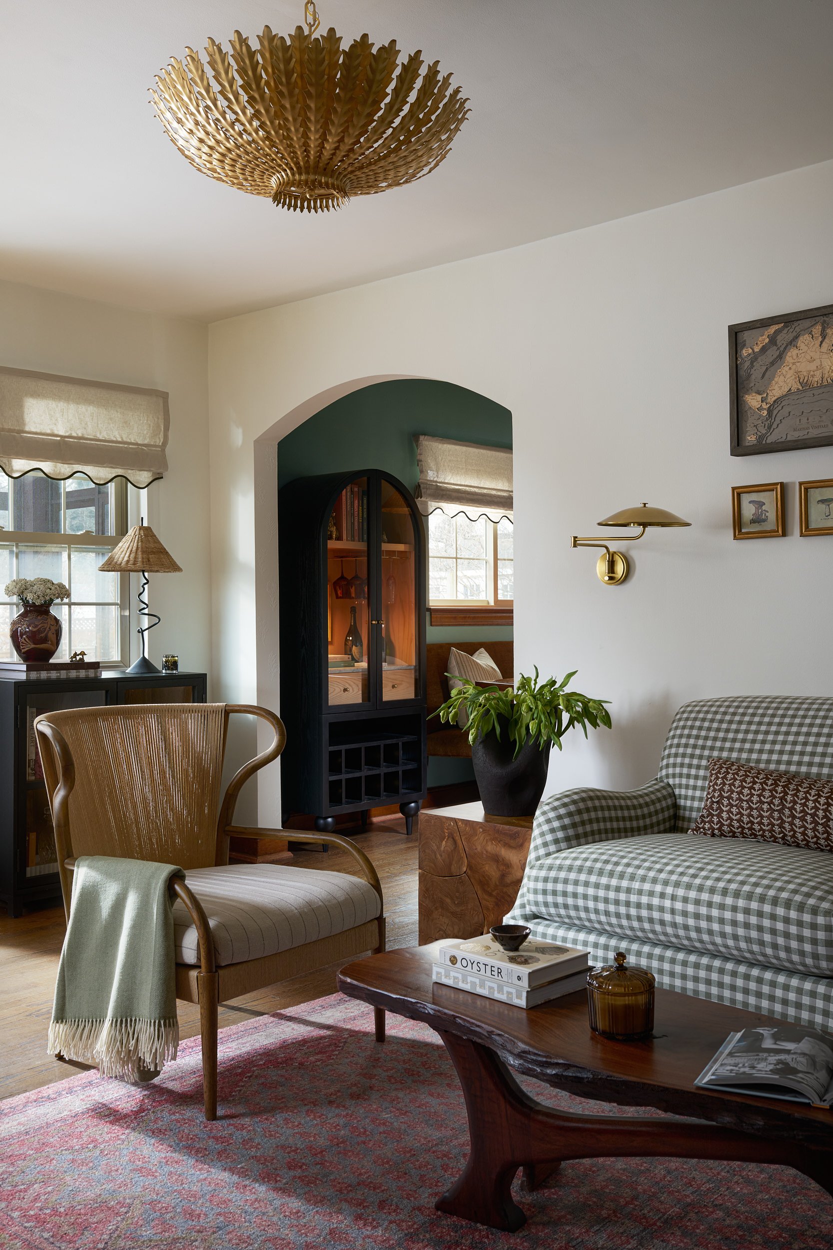 Living room with a gold sunburst chandelier and cane-back chair, interior design photography in Maryland