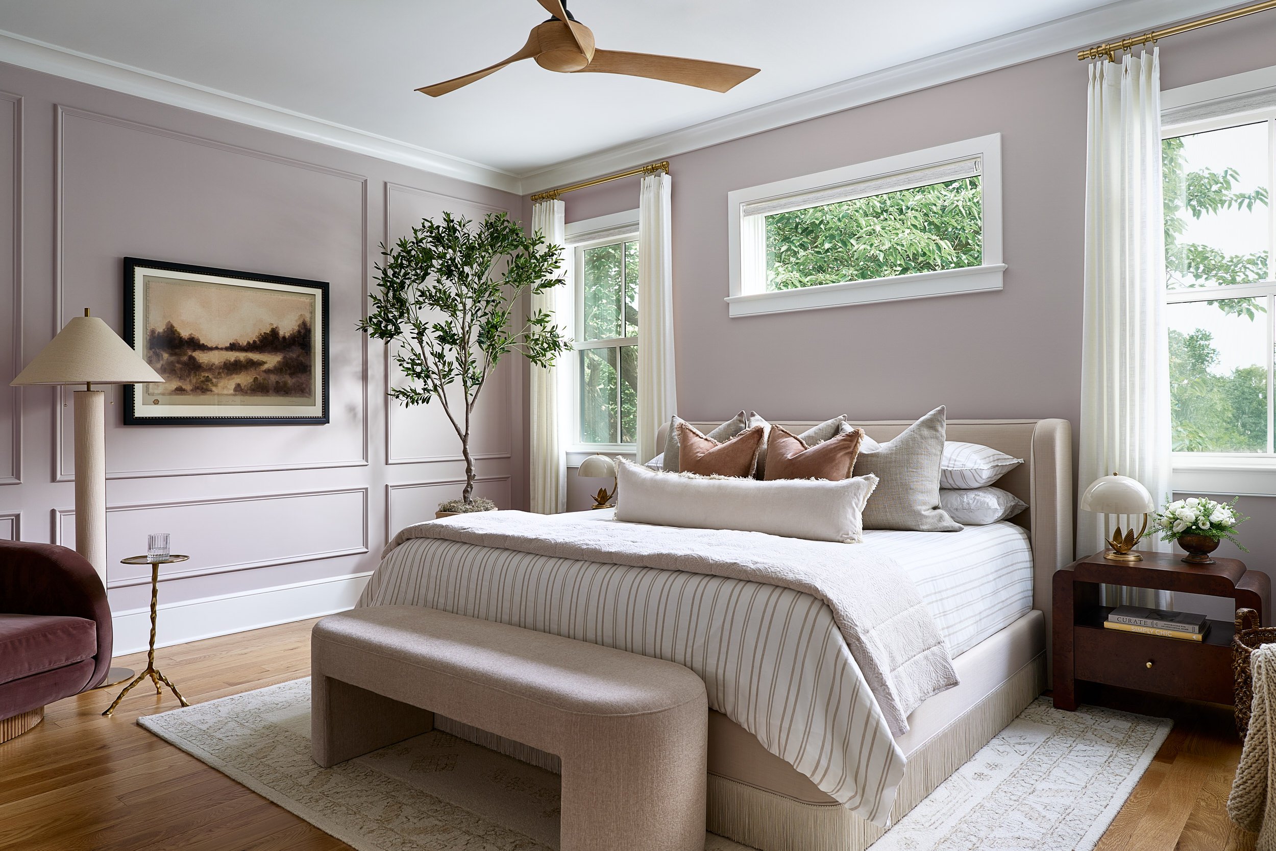Primary bedroom with mauve paneled walls and a wood ceiling fan, interior design photography in Washington, DC