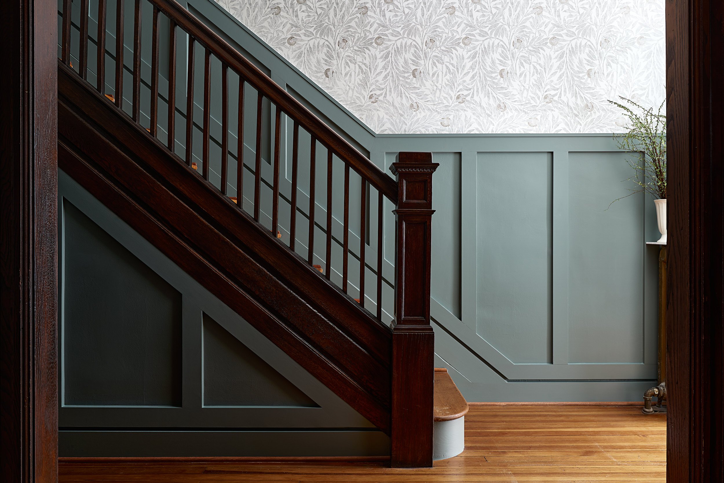 Staircase with dark wood railing and floral wallpaper, interior design photography in Washington, DC