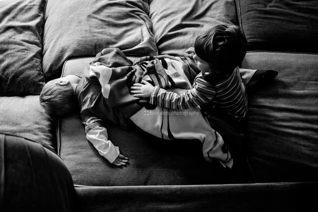 love is getting your brother a blanket when he's worn out from jumping off the couch.