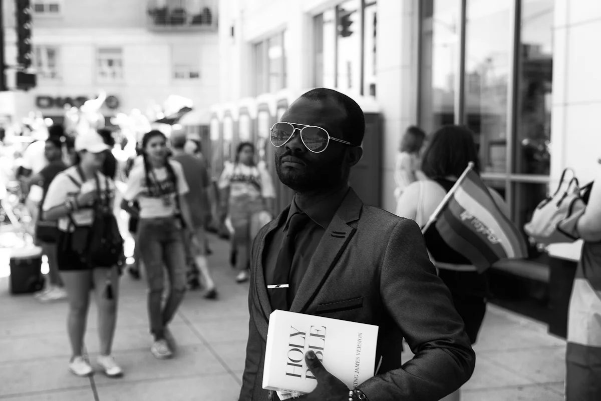 Man holding the Bible during Pride Parade, Chicago, 2018