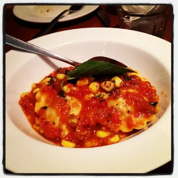 Ravioli with fire roasted corn and tomato basil sauce